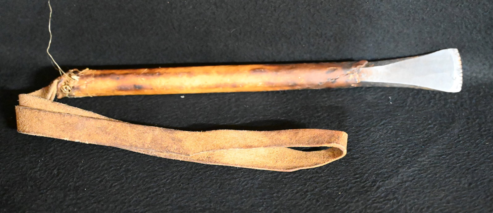 Plains Gun Barrel Hide Scrapper. A hammered down gun barrel wrapped in hide with a leather strap: Plains Gun Barrel Hide Scrapper. A hammered down gun barrel wrapped in hide with a leather strap handle. 16 inches long not including the leather strap.