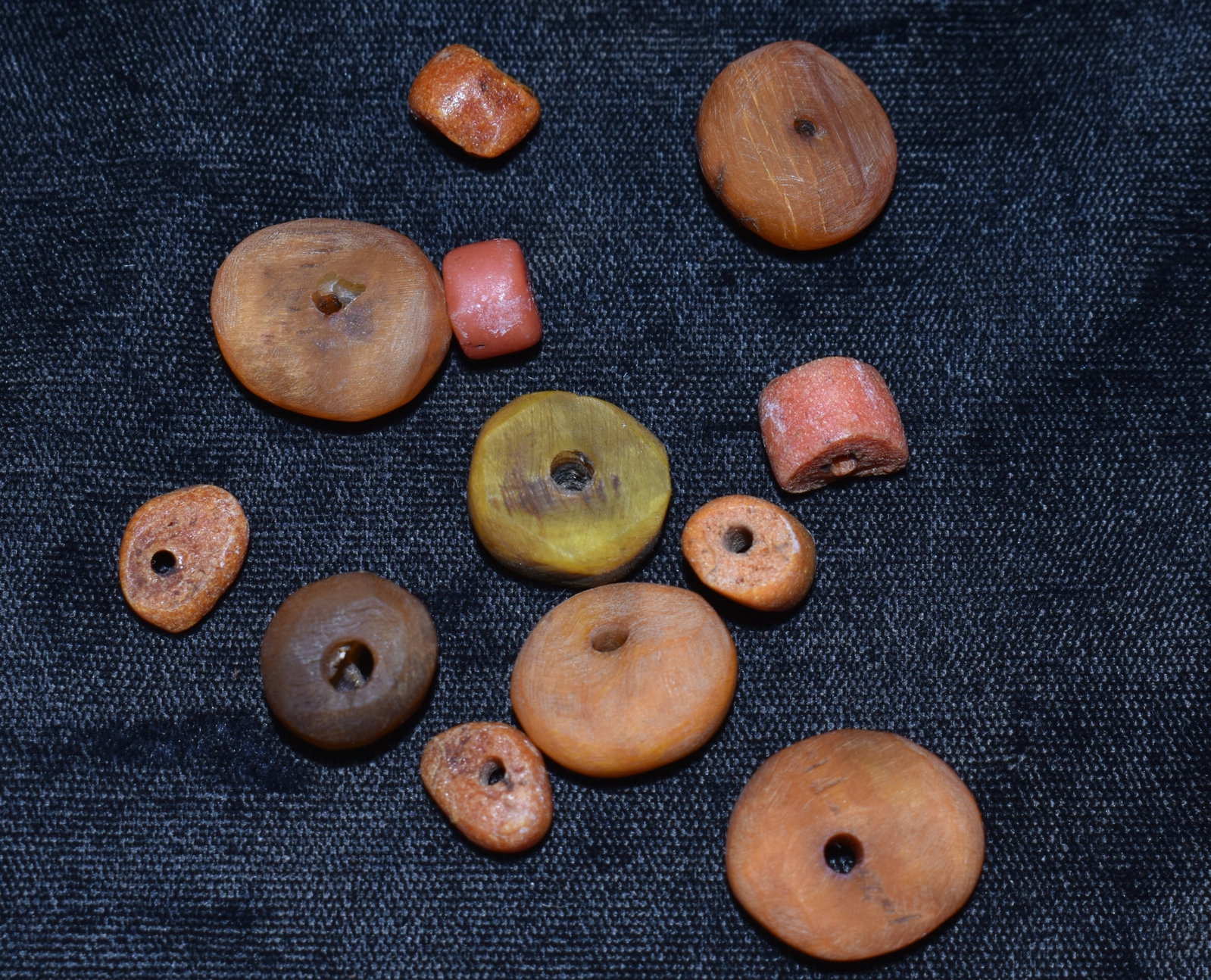 12 Old Tribal African Amber Beads found in north Africa: 12 Old Tribal African Amber Beads found in north Africa. Tested these using the salt water test. The 4 larger ones are patinated butterscotch amber and the smaller ones are an orange color of amber. T
