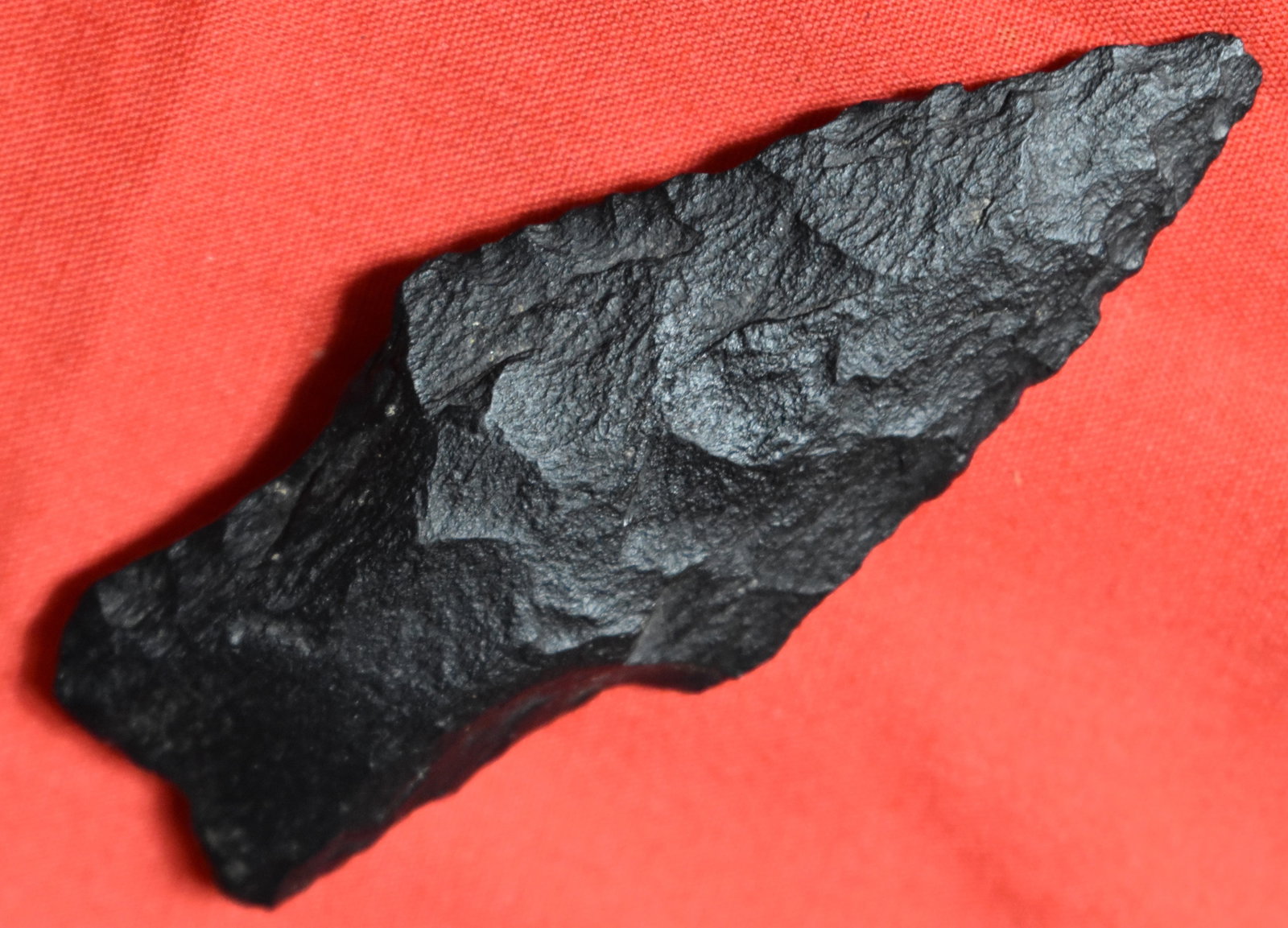 2 5/8" Earless Calf Creek found in Cooper County, Missouri: 2 5/8" Earless Calf Creek found in Cooper County, Missouri. Made of either a rough form of excello chert or a form of riolite. Remnants of the weaved notching to the base help identify this piece. Cal