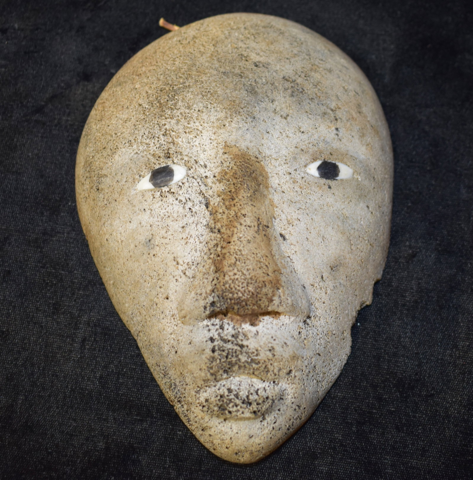 Inuit Eskimo Whale Bone Figural Face Carving w/ Inset Eyes found on St Lawrence Island, AK: Inuit Eskimo Whale Bone Figural Face Carving. The eyes are made of a whiter bone and the pupils of the eyes appear to be some kind of other material that was inset to the eyes and ground or carved smo