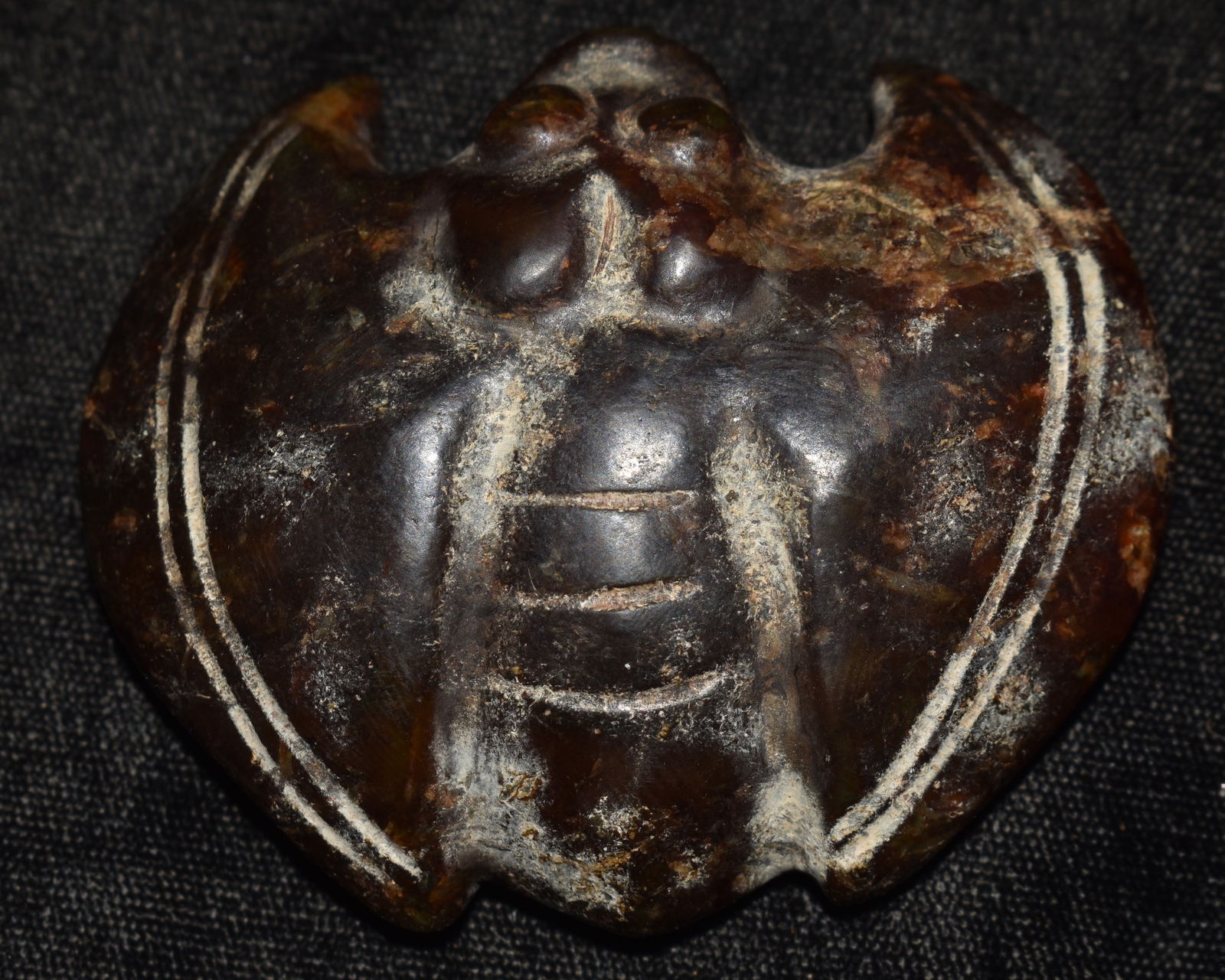 Finely Crafted Neolithic Jade Bat Pendant found in Liaoning Province, China: Finely Crafted Neolithic Jade Bat Pendant found in Liaoning Province, China. The material appears to be a dark brown or black form of Jade. China has a variety of Jade colors that have been used for t