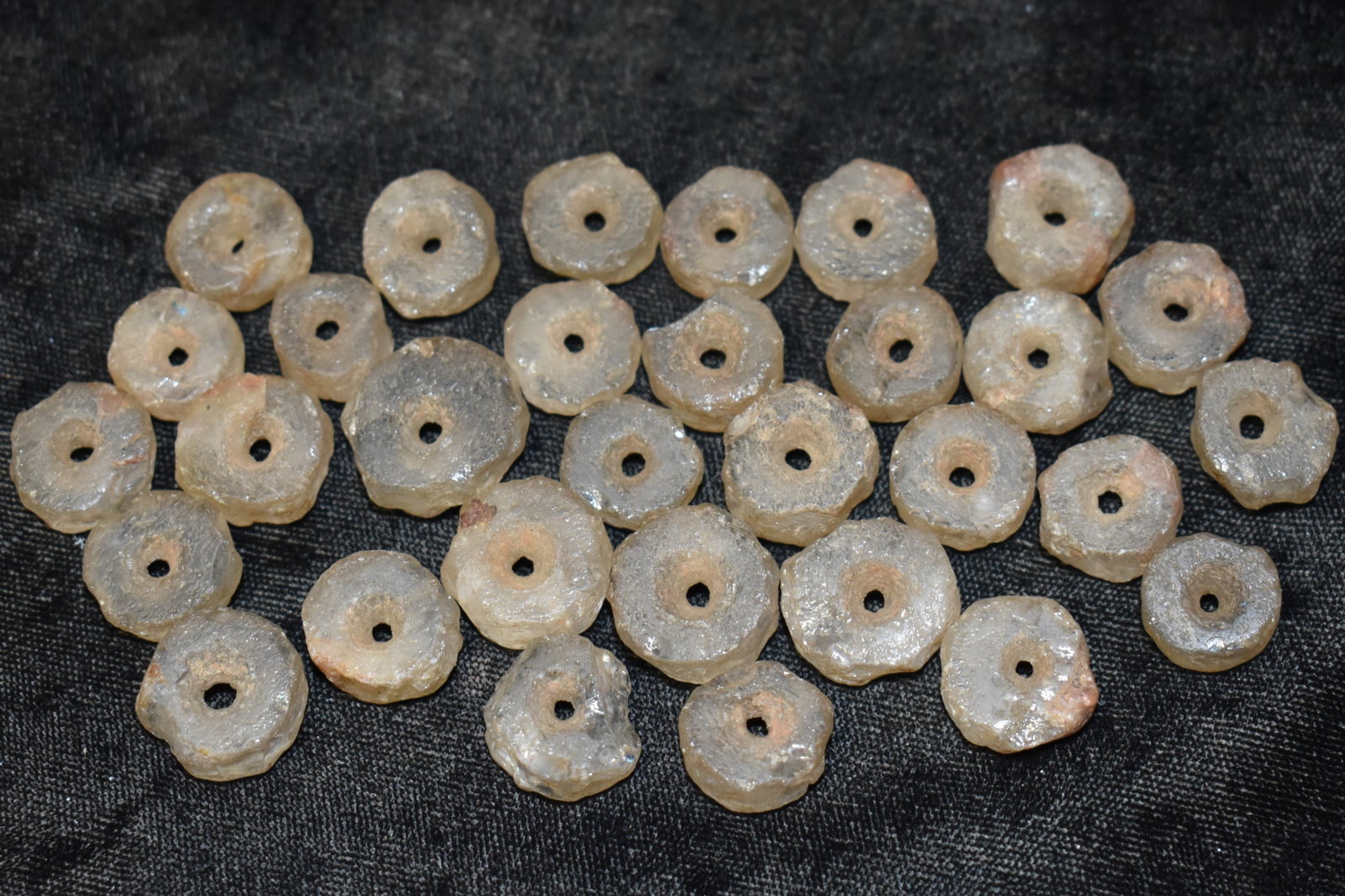 30+ Neolithic Transluscent Quartz Beads found in Africa: 30+ Neolithic Transluscent Quartz Beads found in Africa. These appear to have came from the same necklace. Made of a semi-transluscent clear quartz. Beads measure 1/2" to 3/4".