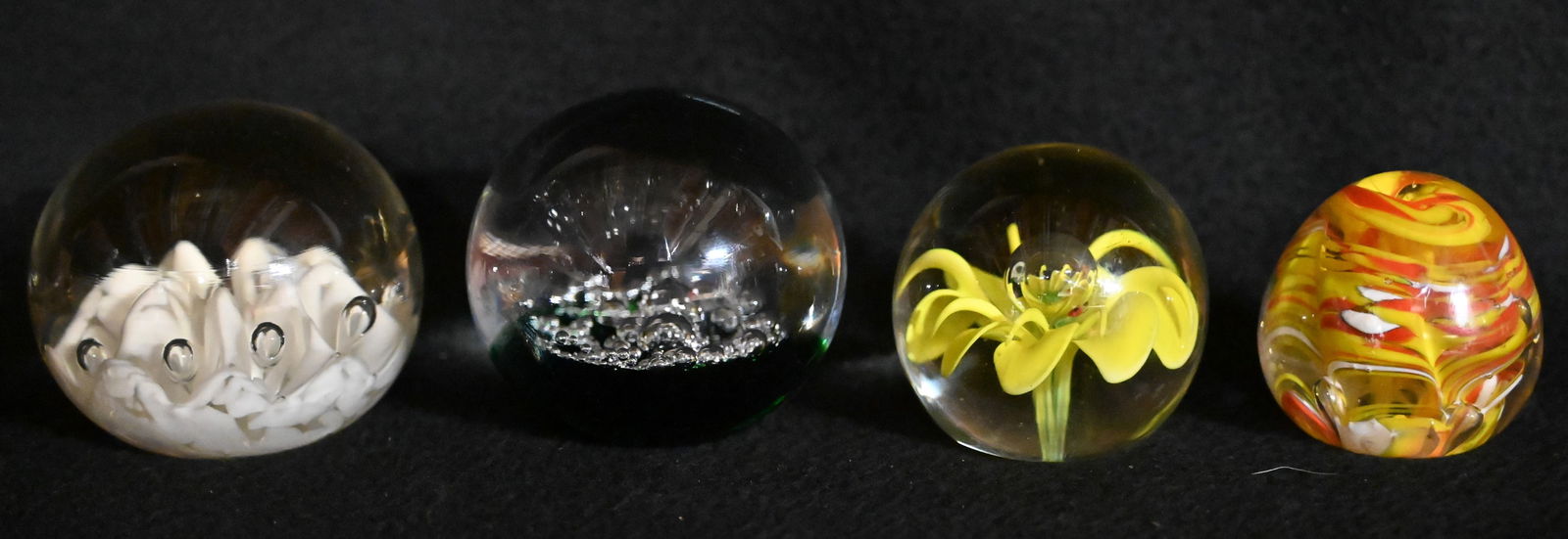 4 Hand Blown Glass Paperweights with flowers, bubbles and other designs largest is 3 1/4" across. (1 of 7)