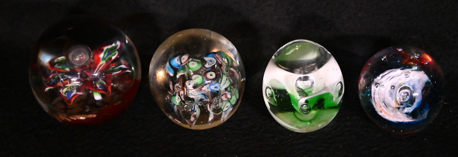 4 Hand Blown Glass Paperweights with flowers, bubbles and other designs largest is 3" across. (1 of 10)