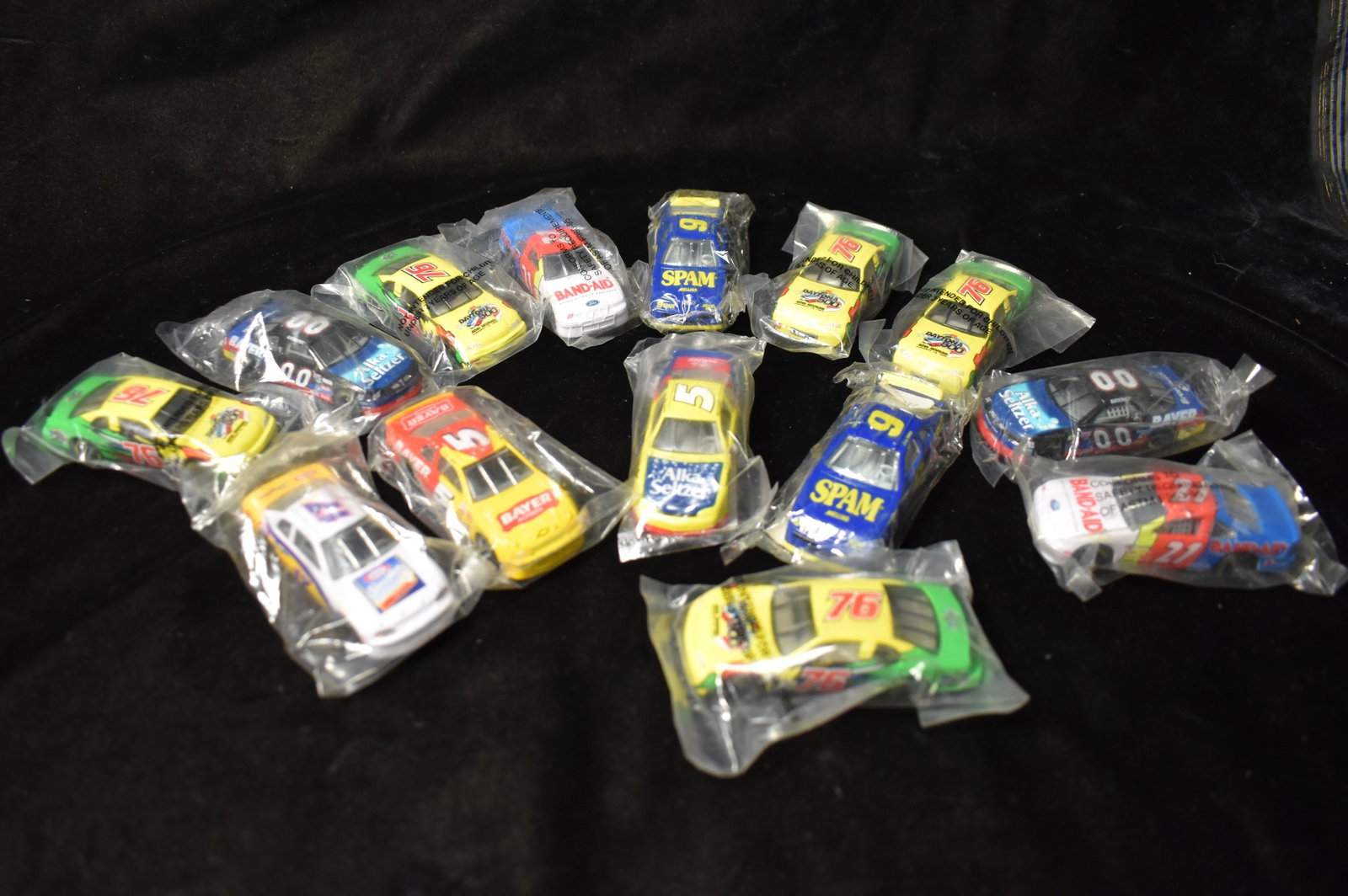 13 Racing Champions 1990's NASCAR 1:64 Diecast Baggy Cars: 13 Racing Champions 1990's NASCAR 1:64 Diecast Baggy Cars. Band-Aid, Bayer, Daytona 500, SPAM, Alka Seltzer and Craft Singles. New in their original bags.