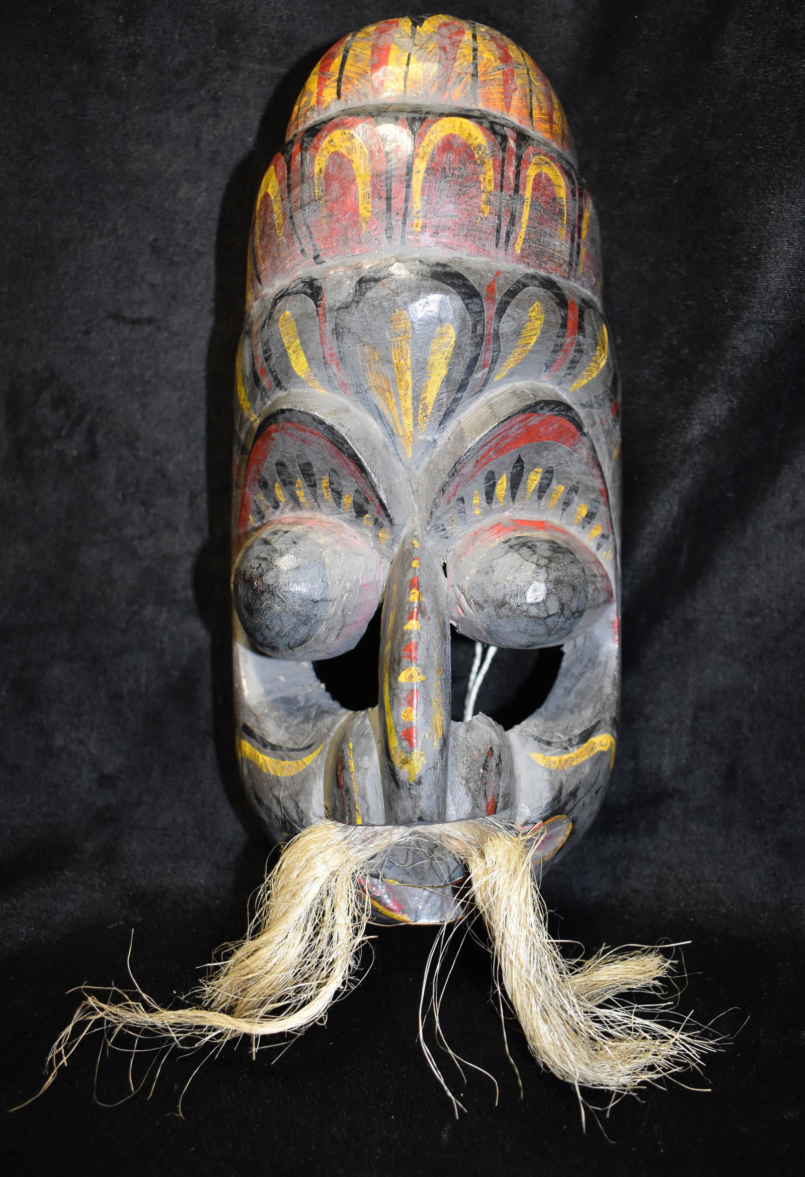 Sri Lanka Kolam or Sanni - Demon Mask - Mid Century or Older: Sri Lanka Kolam or Sanni - Demon Mask. This mask was most likely one that was hung on the wall to ward off disease or demons. A solid piece hand carved and painted wood. The collection this mask is fr