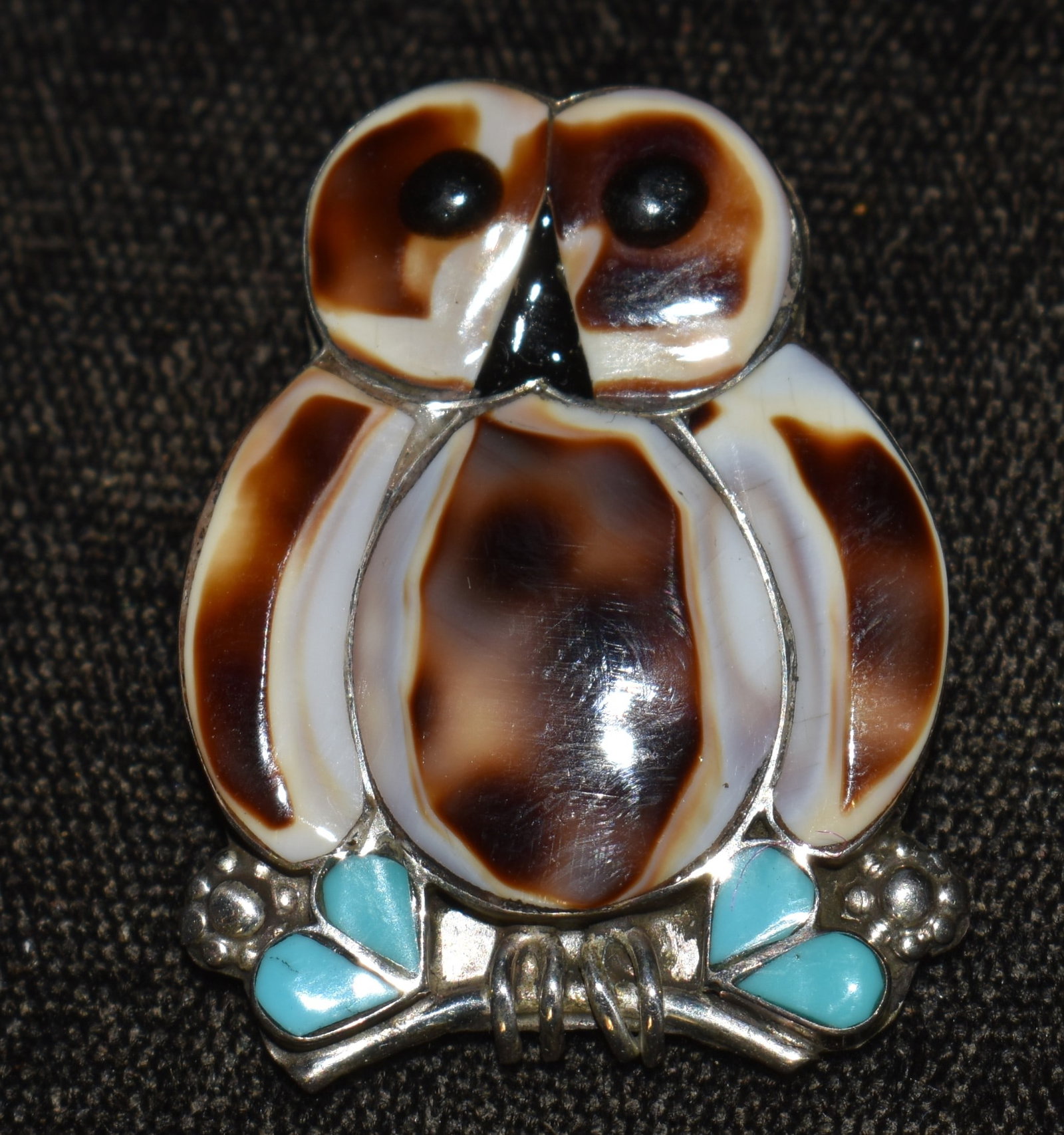 Zuni Sterling Silver Owl Brooch made by R. Calistewa: Zuni Sterling Silver Owl Brooch made by R. Calistewa. New condition. Materials used appear to be turqouis, shell and onyx. Brooch measures over 1 1/4" tall and weighs 6 grams.