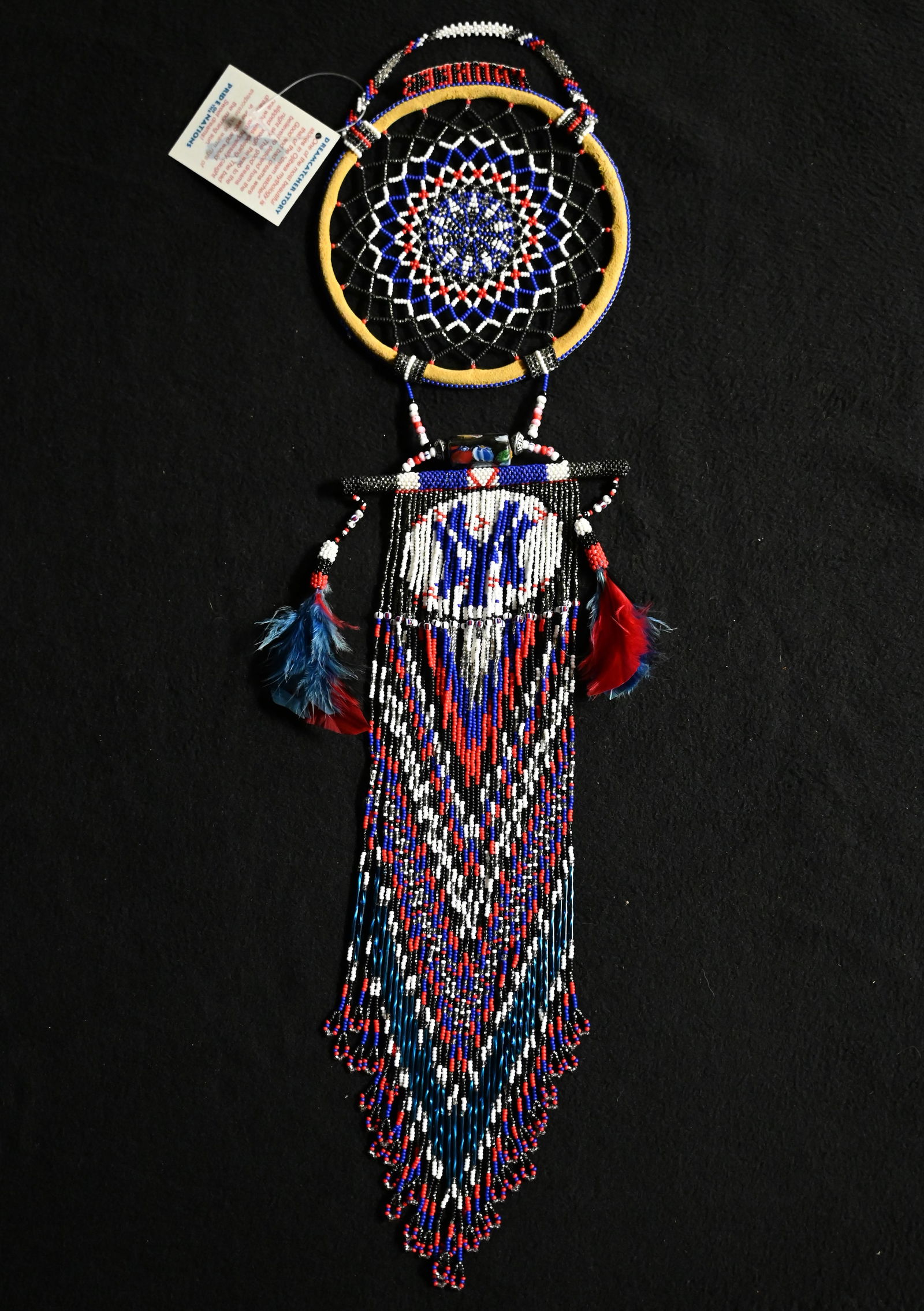 21" Beaded Dream Catcher with feather drops. Beautiful and well made piece of art. Ex: Pride of: 21" Beaded Dream Catcher with feather drops. Beautiful and well made piece of art. Ex: Pride of The Nations Store. The Store represented many of the tribes artwork from across the country. Sioux and O