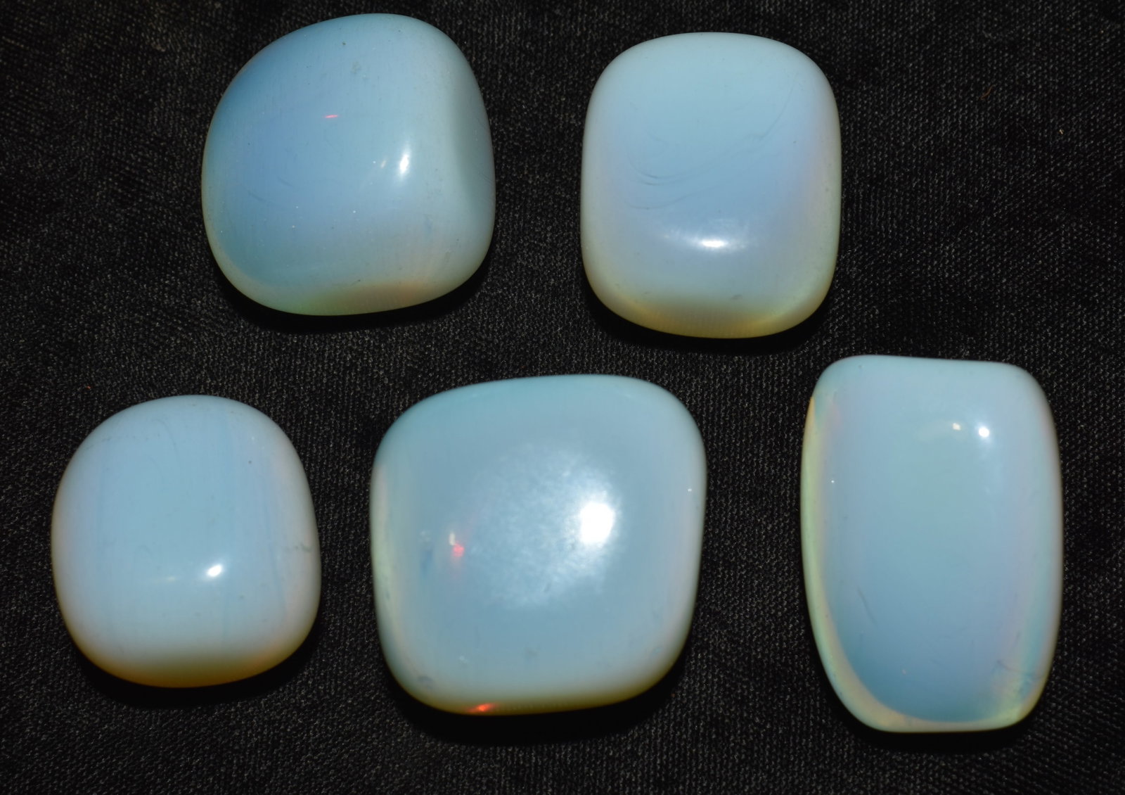 5 Polished Rainbow Moonstones from Peru: 5 Polished Rainbow Moonstones from Peru. Nice size samples suitable for jewelry making projects. These measure 1 1/8" to a little over 1 1/2" wih thicknesses of 5/8" to 7/8". Found in the Andes of Per
