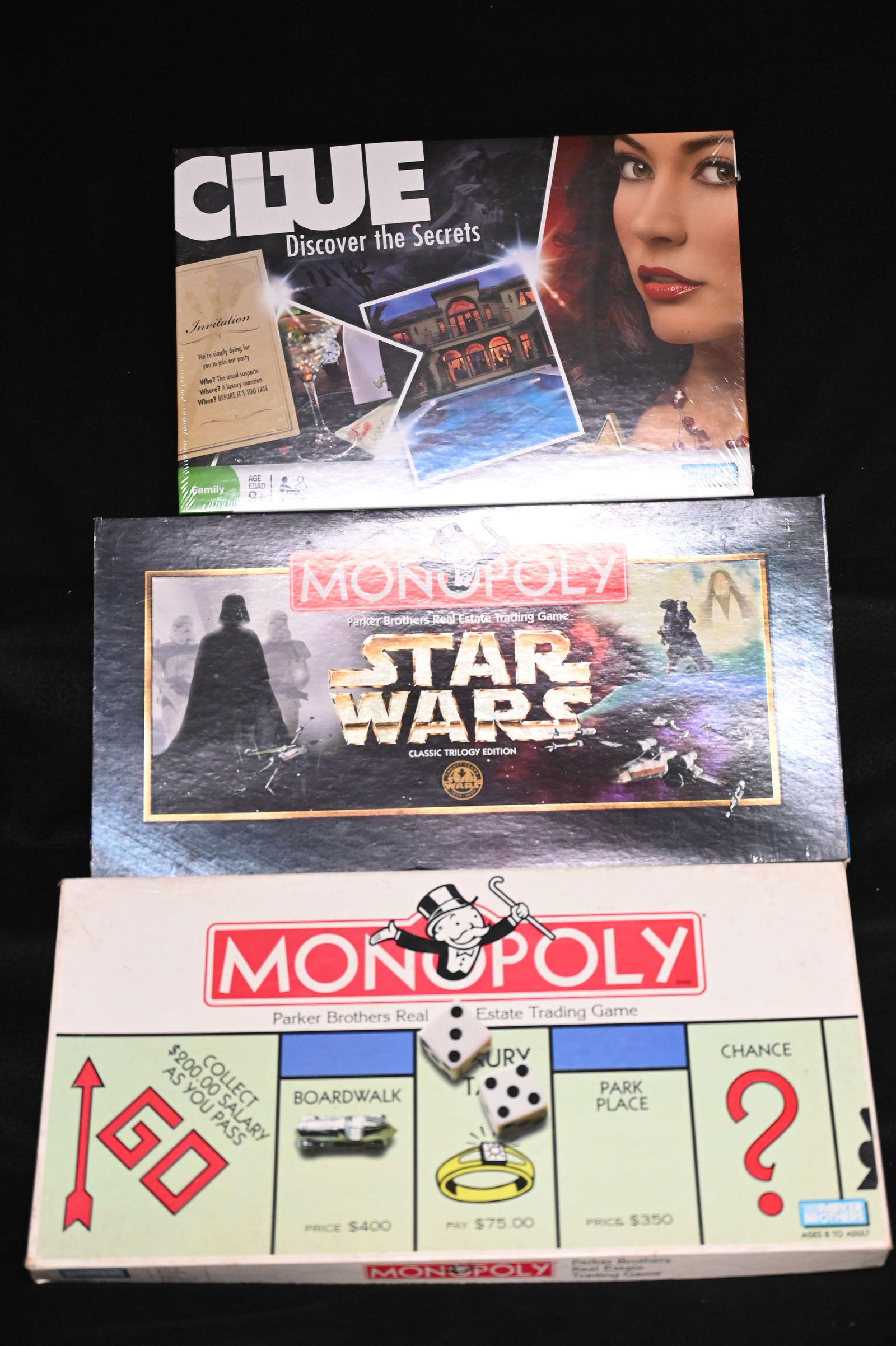 3 Vintage Board Games. Starwars Monopoly, Monopoly, and Clue.  All gamepieces appear to be inside. (1 of 5)