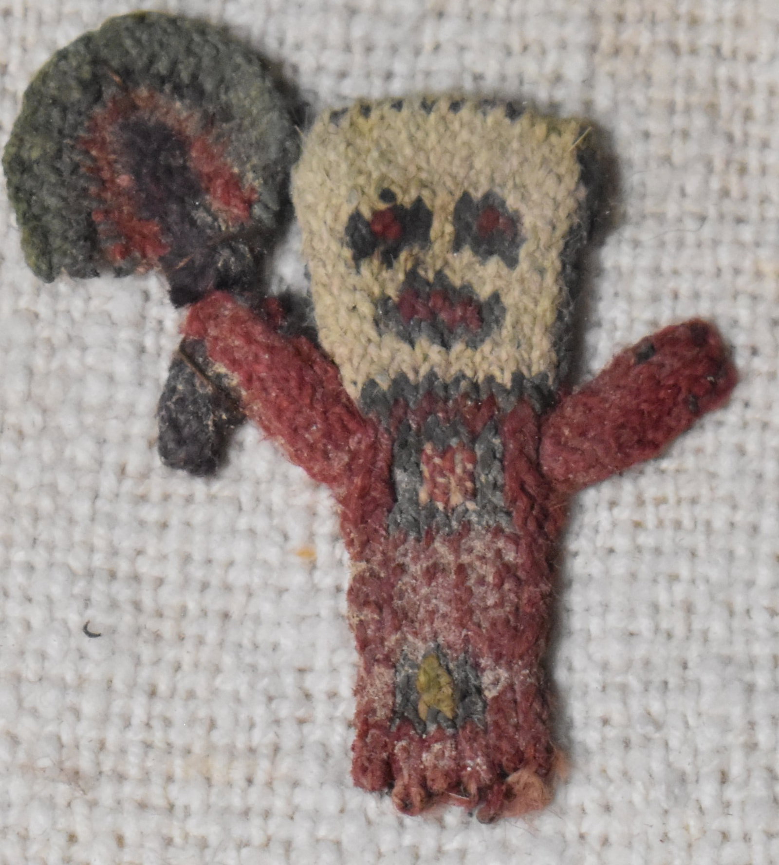Nasca Anthropomorphic Embroidery of a Nasca Warrior - 200 BCE to 600 CE: Nasca Anthropomorphic Embroidery of a Nasca Warrior - 200 BCE to 600 CE. Colorful example of the traditional textiles made by the Nasca people from the Andes in Peru. It is made of camelid fibre and c