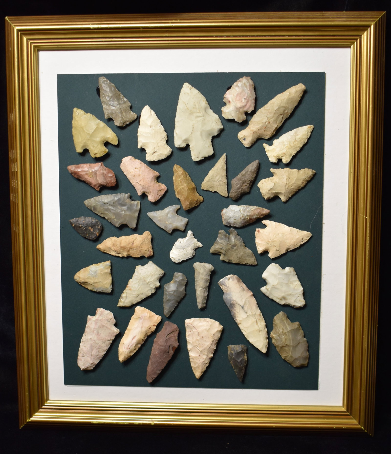 Frame of 33 Arrowheads Found in the Midwest: Frame of 33 Arrowheads Found in the Midwest. Assortment of arrowheads Missouri, Illinois and Indiana from the Steve Manos Collection. Points in this group measure 1 1/4" to 3 3/8" Frame measures 1" by