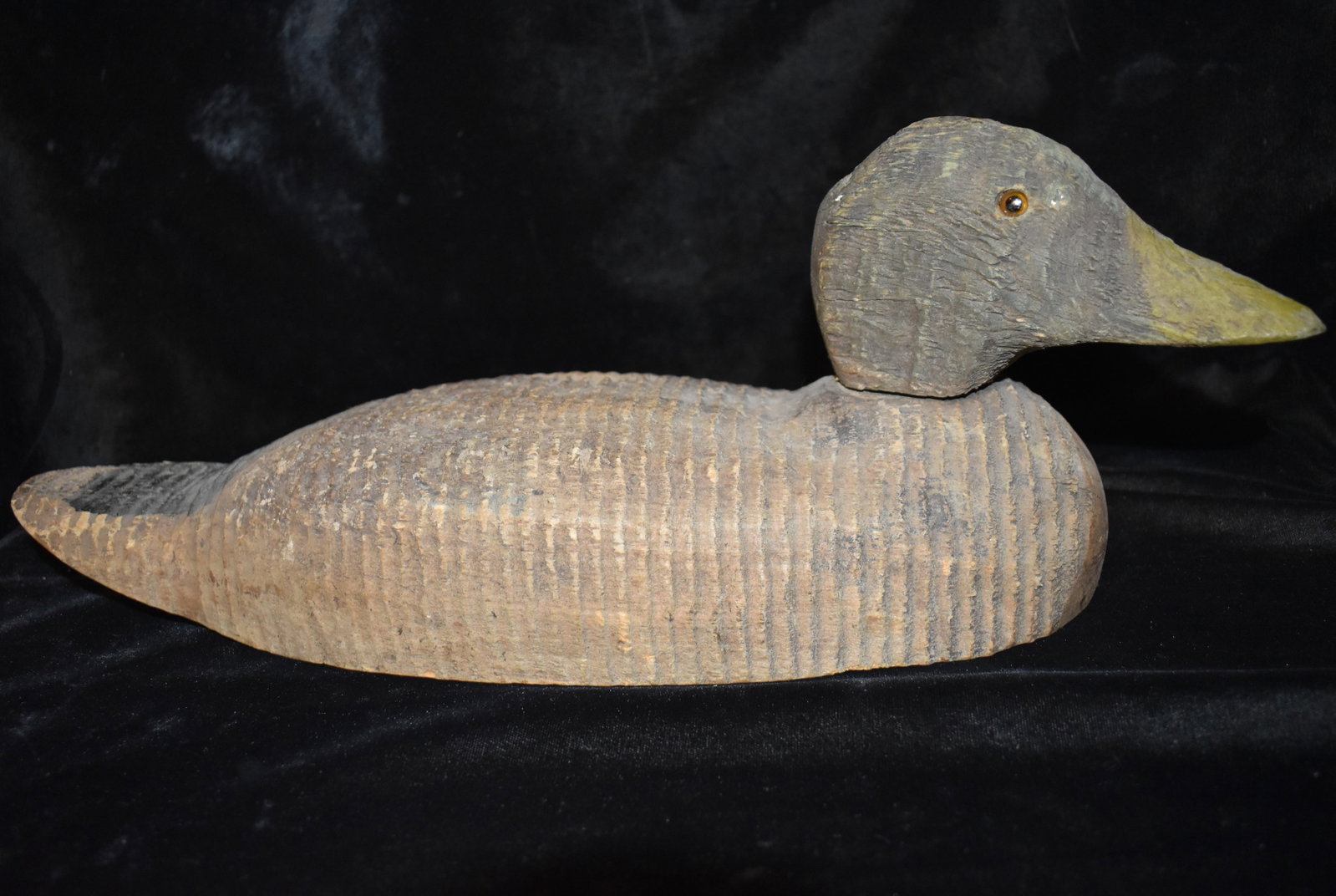 Vintage Hand Carved Wood Duck Decoy: Vintage Hand Carved Wood Duck Decoy. Faded from time and use this old decoy is still in good shape for its age. Has a head that seats snugly on a post that can be turned. Measures 14 1/8" Long. No mak