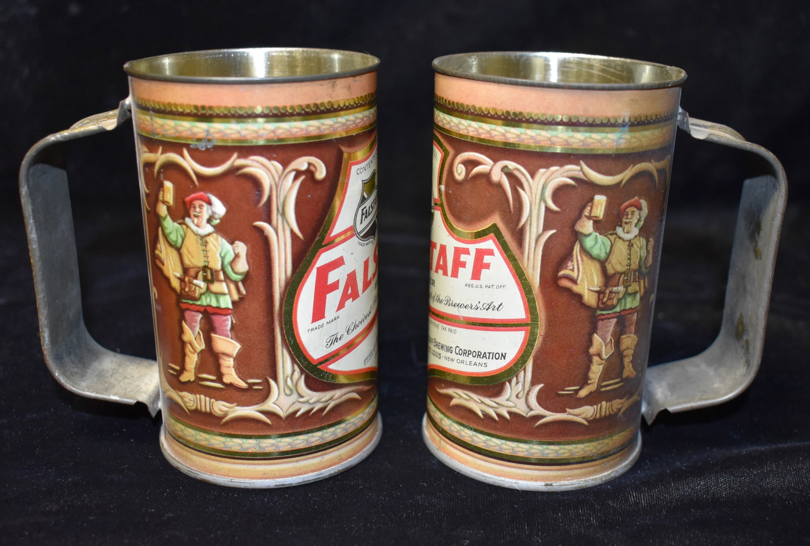 Two 1940's FALSTAFF Beer Can Handled Mugs: Two 1940's FALSTAFF Beer Can Handled Mugs. Minor blemishing. Metal has a tarnish from age. Measures 4 1/2" Tall.