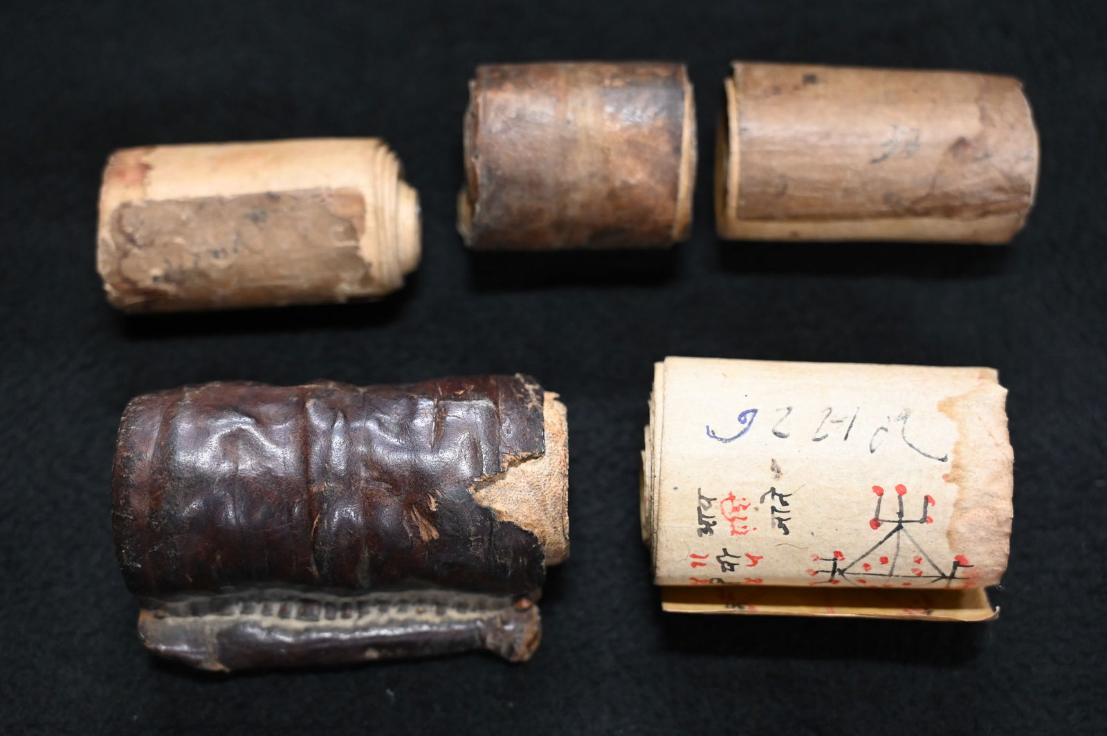 5 Chinese Scrolls appear to be very old. One is in a leather sleeve. Largest is 3 1/4" wide.: 5 Chinese Scrolls appear to be very old. One is in a leather sleeve. Largest is 3 1/4" wide.