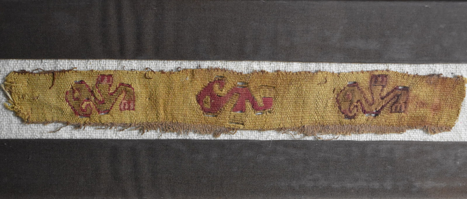 Nasca Ornithomorphic Embroidery Made by the Nasca 200 BCE to 600 CE: Nasca Ornithomorphic Embroidery Made by the Nasca 200 BCE to 600 CE. Colorful example of the traditional textiles made by the Nasca people. Made of camelid fibre and cotton. Nicely framed long ago. Th