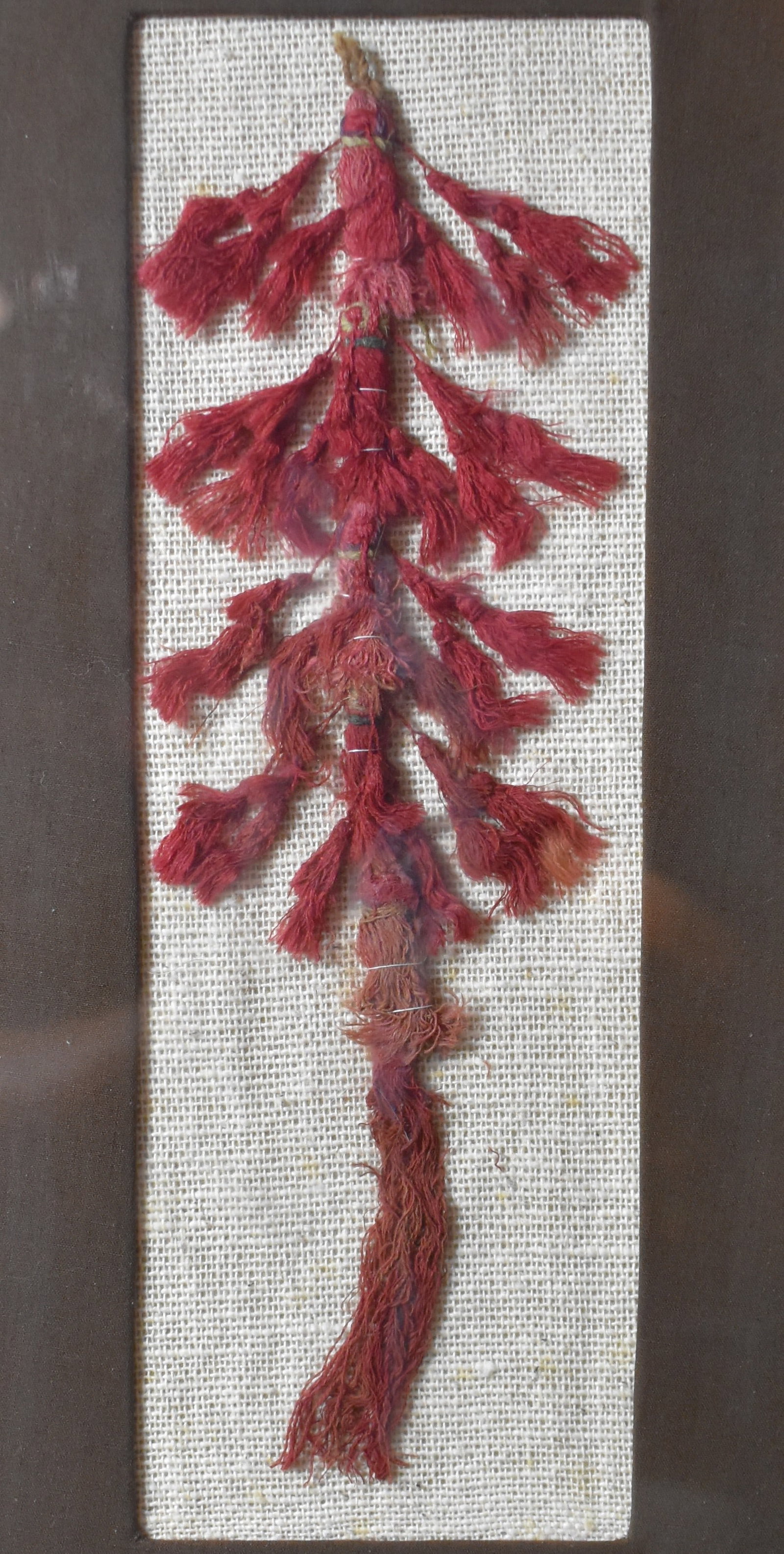 Nasca Ornamental Tassel Made by the Nasca 200 BCE to 600 CE: Nasca Ornamental Tassel by the Nasca 200 BCE to 600 CE. Colorful example of the traditional textiles made by the Nasca people. Made of camelid fibre and cotton. Nicely framed long ago. The tassels att