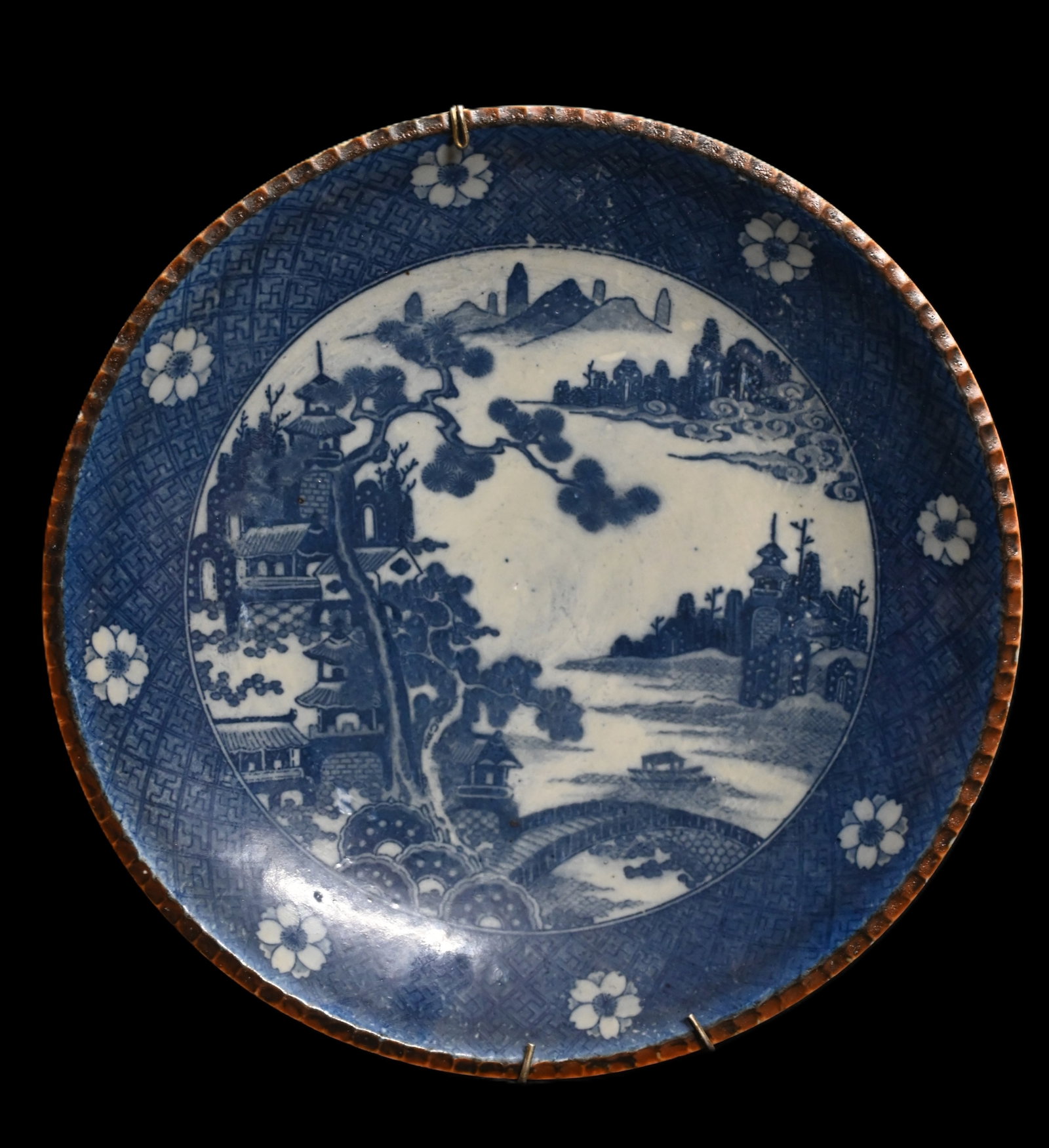 Japanese Arita Porcelain Plate from the Meiji Period Blue and White Porcelain with Brown Glazed: Japanese Arita Porcelain Plate from the Meiji Period Blue and White Porcelain with Brown Glazed Coggled Trim circa late 19th Century measures 12 1/8 inches across.