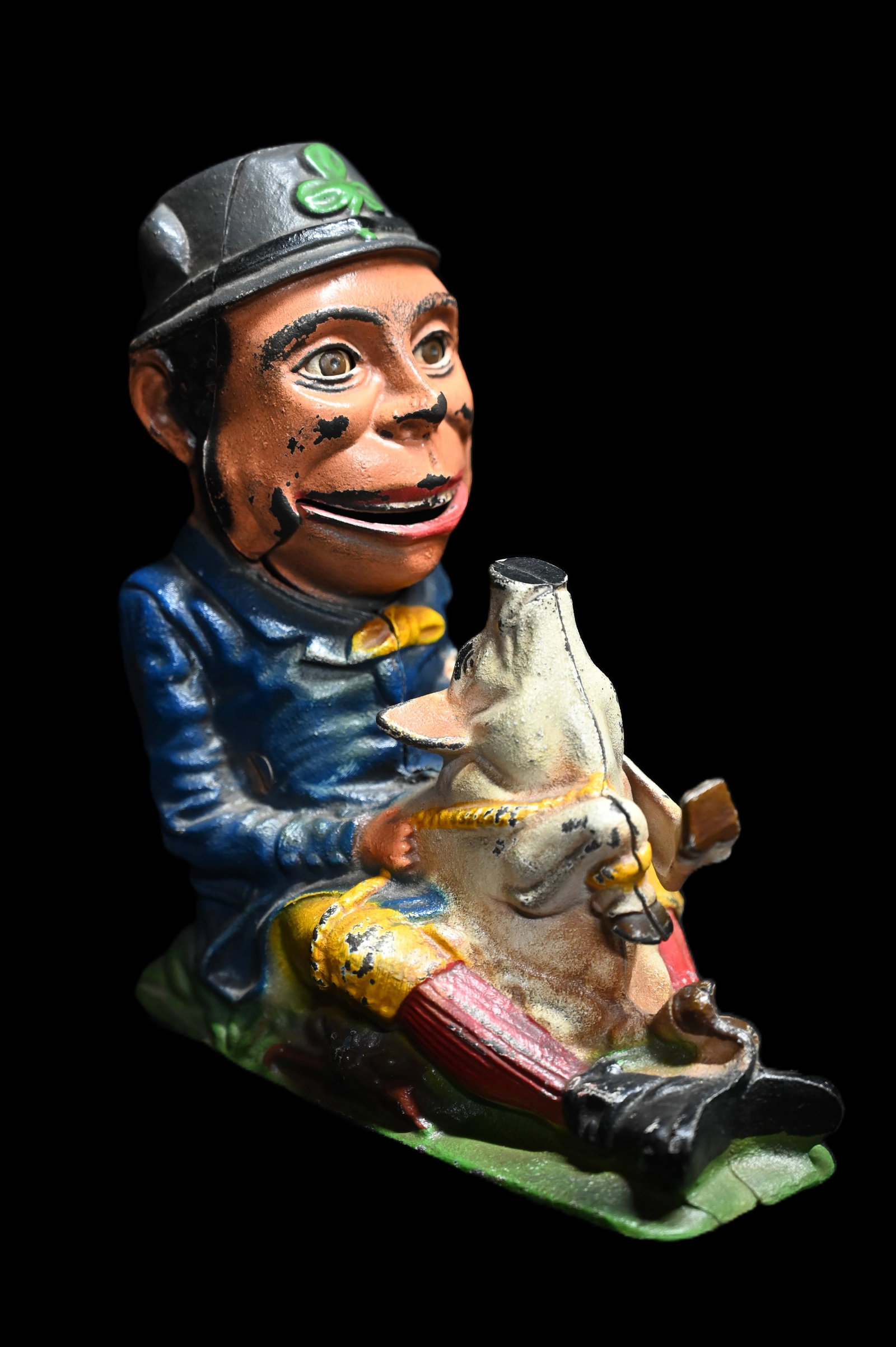 Vintage Cast Iron Leprechaun Bank.: Vintage Cast Iron Leprechaun Bank. The leg of the pig is the lever that opens the leprechaun's mouth to put the coin on his tounge. Release the lever an the Lephrechaun eats the coin. 7 3/4" tall by 7