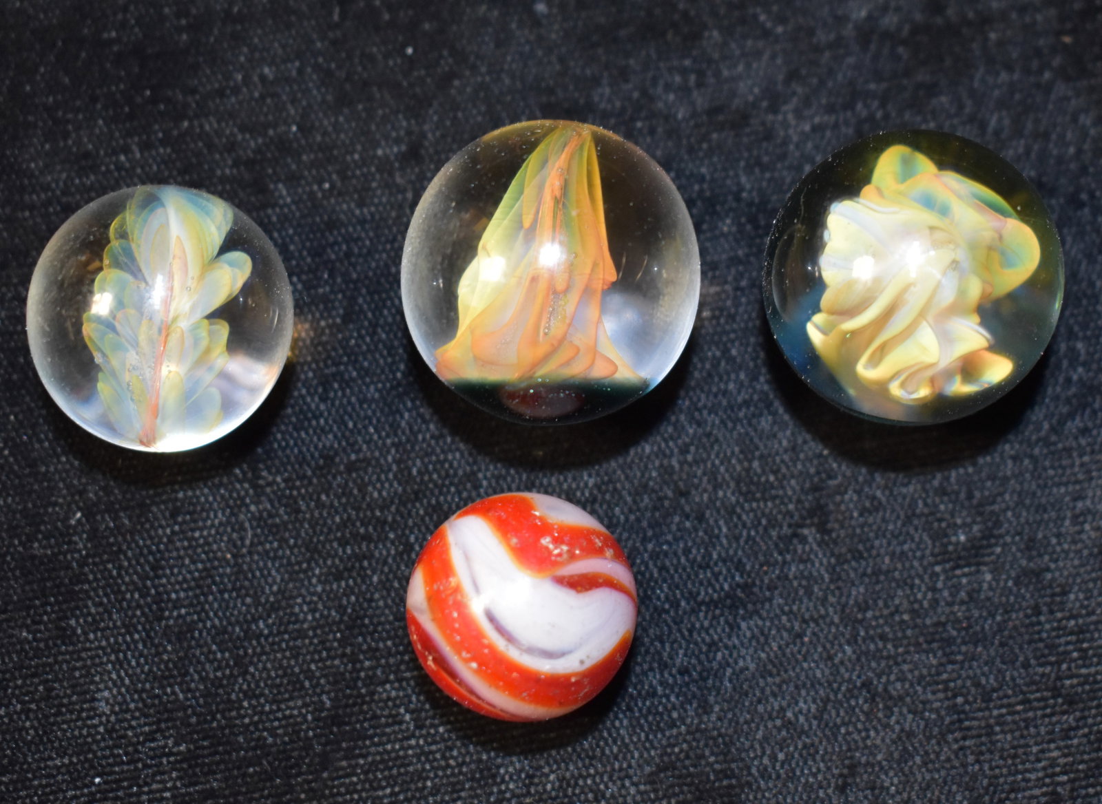 3 Flower Implosion Marbles and an Akro Agate: 3 Flower Implosion Marbles and an Akro Agate. See pictures on the floral marbles. We arnt familiar with that type. The 3 of those are in excellent condition. The akro agate has a good number of hit ma