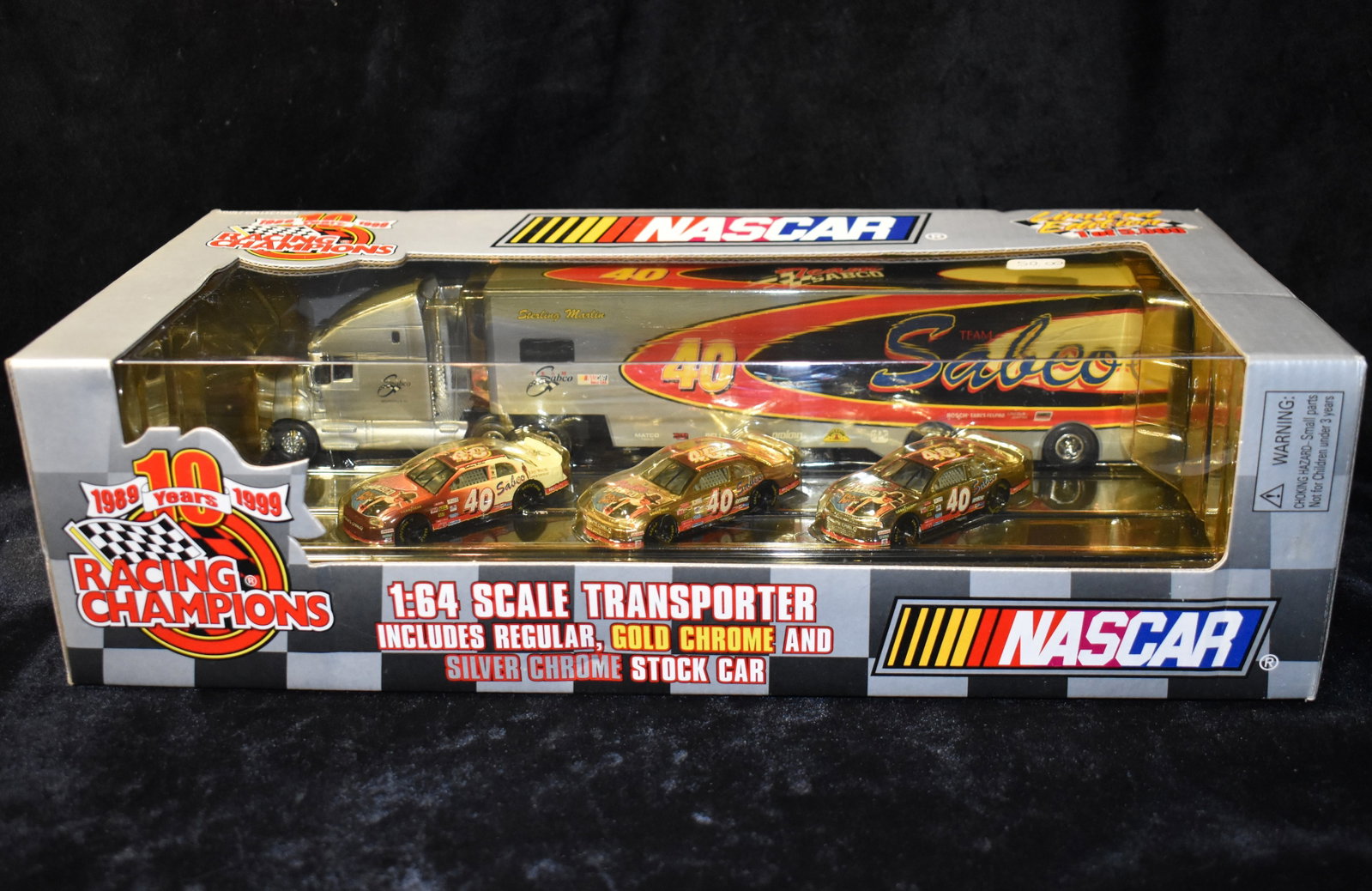 1999 1:64 Scale Transporter w/ Gold, Silver & Regular Stock Cars Diecast Racing Champions 10 years: 1:64 Scale Transporter w/ Gold, Silver & Regular Stock Cars Diecast Racing Champions 10 Years. Made in 1999. Limited edition 1 of 5000. New in the box.
