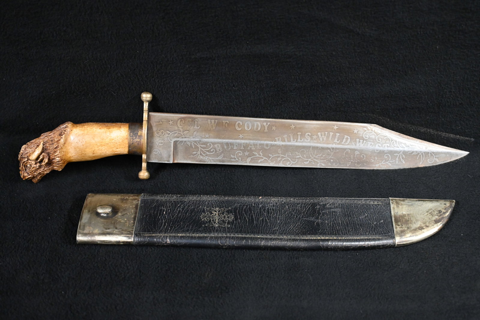 21" Bone Buffalo Bill Cody Bowie Knife. 15" Blade marked Col. W. F. Cody 1896 Buffalo Bills Wild: 21" Bone Buffalo Bill Cody Bowie Knife. 15" Blade marked Col. W. F. Cody 1896 Buffalo Bills Wild West. Made by Nappin Brothers Sheffield. Bone Handle with a Buffalo carved in it. Leather sheath with S