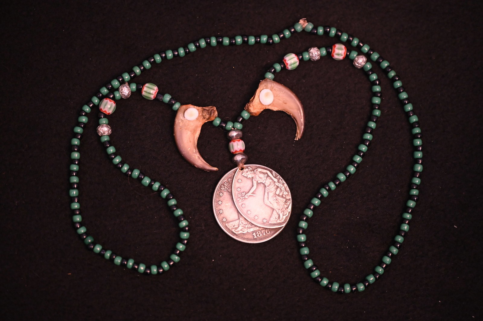 1876 Double Restrike Coin Pendant Necklace with Bear Claws and Green and Black Beads.: 1876 Double Restrike Coin Pendant Necklace with Bear Claws and Green and Black Beads.