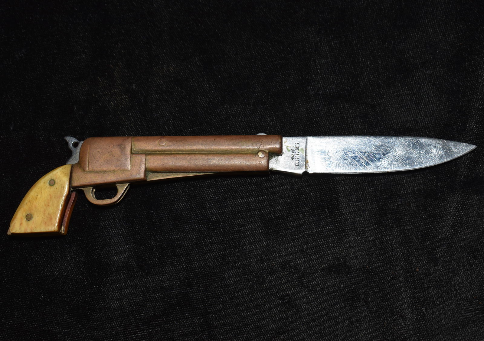 1970's Parker Cutlery Gun Knife "Wild West": 1970's Parker Cutlery Gun Knife "Wild West". This style of knife was popular in the mid 1900's. The handle guards are made of bone (one of them has a chip in it as shown in photos). The main body is c