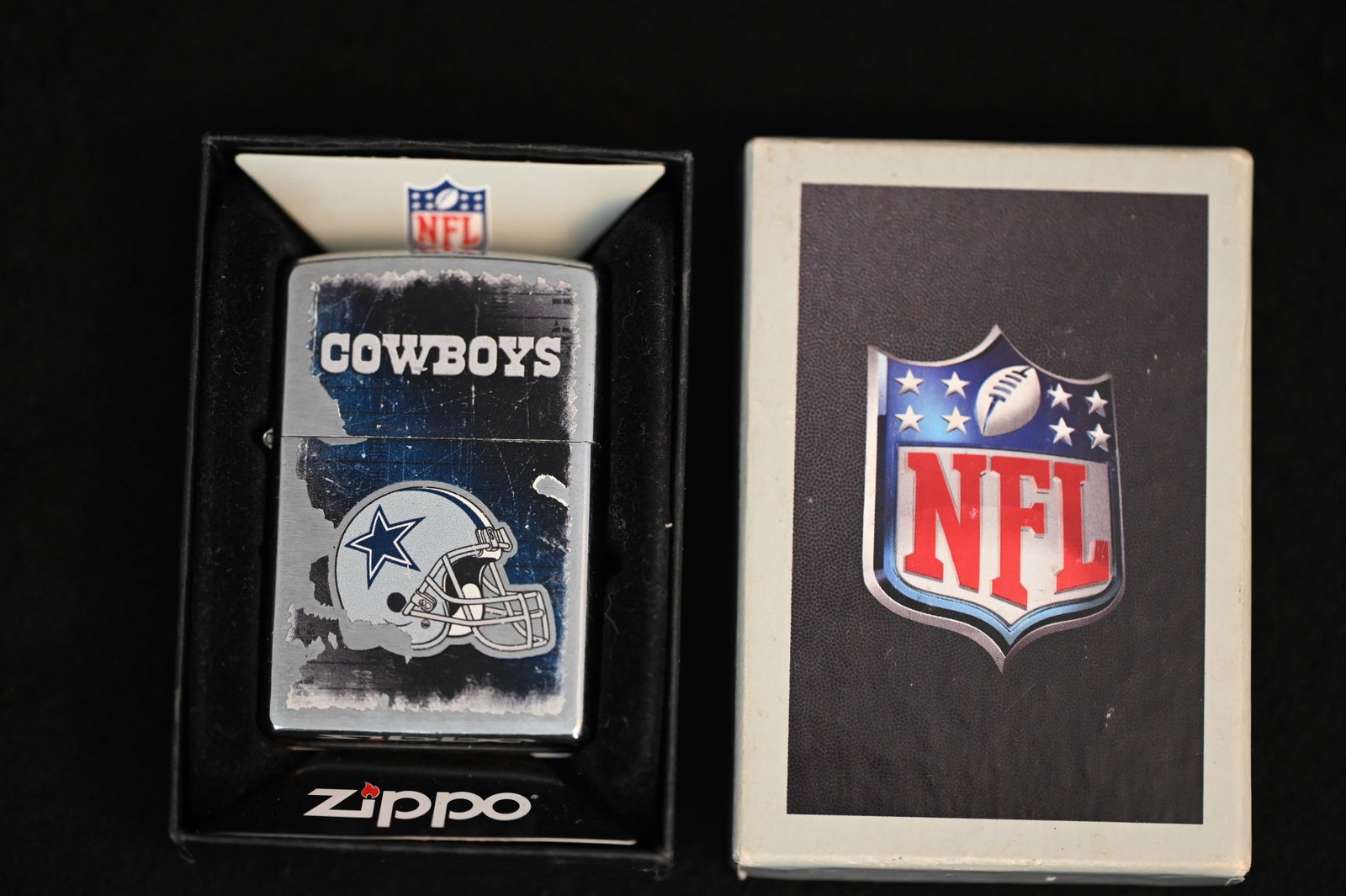 Dallas Cowboys NFL Zippo Lighter in the original box. The lighter is used and worn but not dented.: Dallas Cowboys NFL Zippo Lighter in the original box. The lighter is used and worn but not dented.