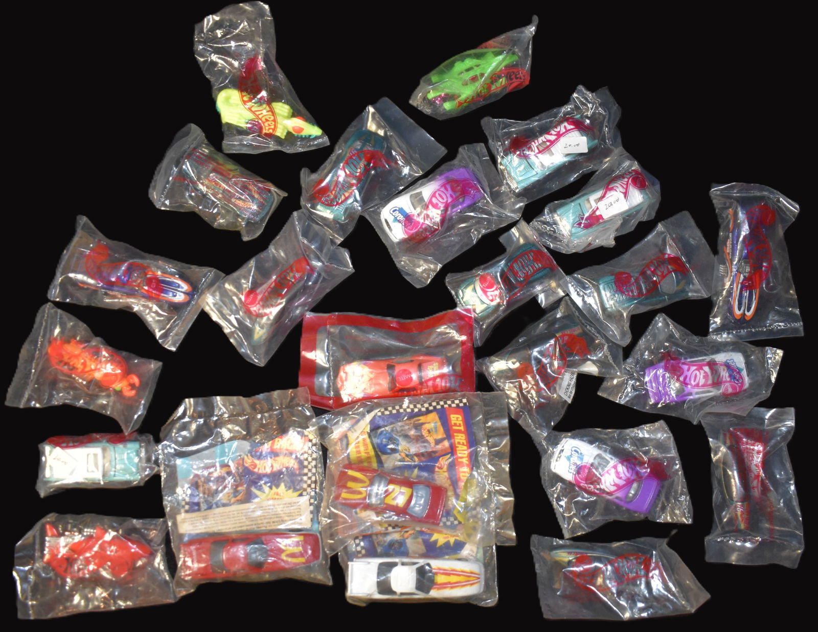 24 Advertising Hot wheels from the 1980's to 1990's Still in the Package.: 24 Advertising or Promotional Hot wheels from the 1980's to 1990's Still in the Package. Lucky Charms, McDonalds, 97 & 98 Bonus Cars, Coronet and others. All appear to be in excellent to mint conditio