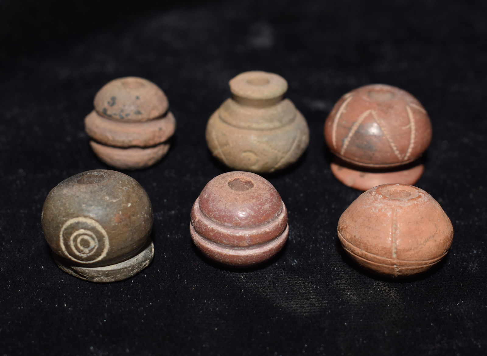 6 Engraved Pre-Columbian Spindle Whorl Beads: 6 Engraved Pre-Columbian Spindle Whorl Beads. Nice examples. These spindle whorls measure approximately 1/2" to 5/8". From the Chuck and Eileen Hoffman Collection. Chuck and his wife spent most of the