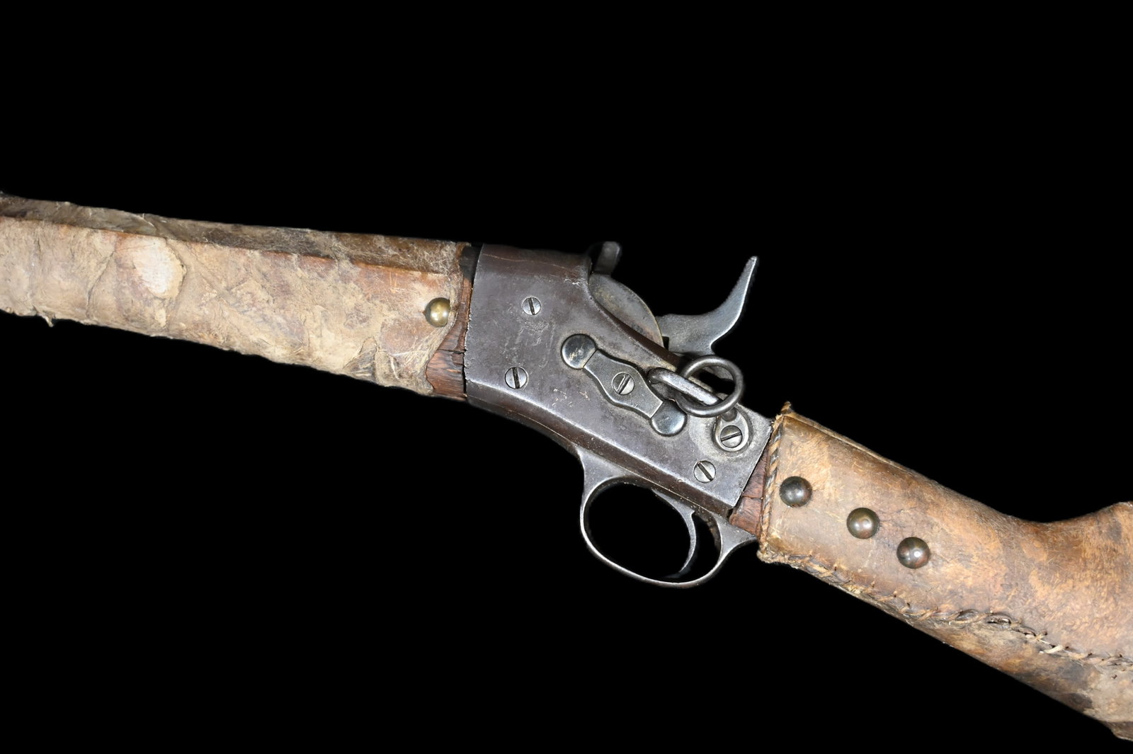 414 Remington .30 Cal Falling Block Carbine Wrapped in Rawhide and Brass Tacked. 20.5" Round: 414 Remington .30 Cal Falling Block Carbine Wrapped in Rawhide and Brass Tacked. 20.5" Round Barrel. Butt plate is missing but common as they were used to scrap buffalo hide. Buttstock is loose. This 