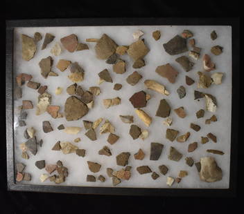 Frame of Pottery Shards, Bone Fragments and Chert Found near Cahokia Mounds, Illinois: Frame of Pottery Shards, Bone Fragments and Chert Found near Cahokia Mounds, Illinois by Kristie Schwab. Largest fragment is approximately 2". Frame measures 16 1/4" by 12 1/4".