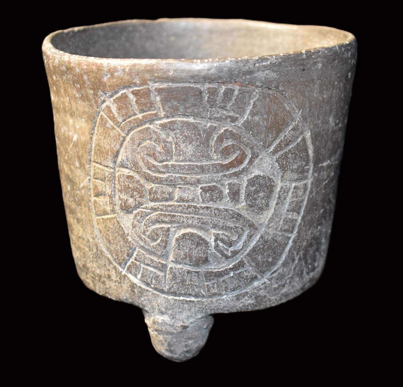 Pre-Columbian Teotihuacan Cylindrical Tripod Jar: Pre-Columbian Teotihuacan Cylindrical Tripod Jar. Very nice example of the type. The incised pattern on two faces represents a deity or religious symbology. Nice piece with no restoration. Measures 4