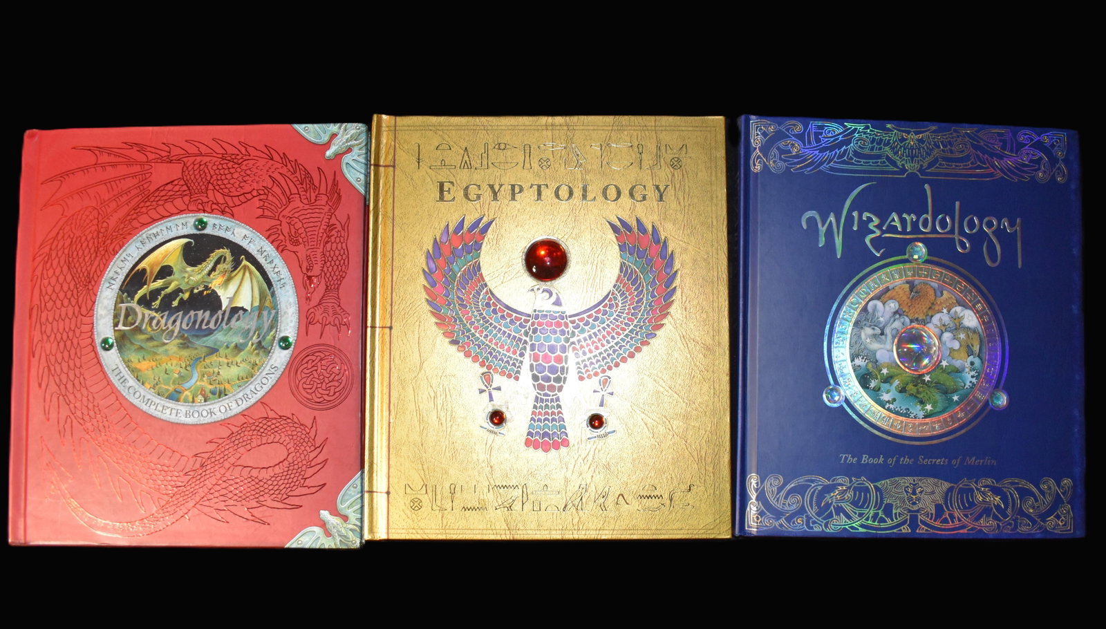 Wizardology, Dragonology & Egyptology by Candlewick - 2003-2005 Hardbacks: Wizardology: The Book of the Secrets of Merlin (Ologies) by Master Merlin 2005; Egyptology - Search for the tomb of Osiris (being the journal of Miss Emily Sands, November 1926) Ian Andrew, Nick Harri