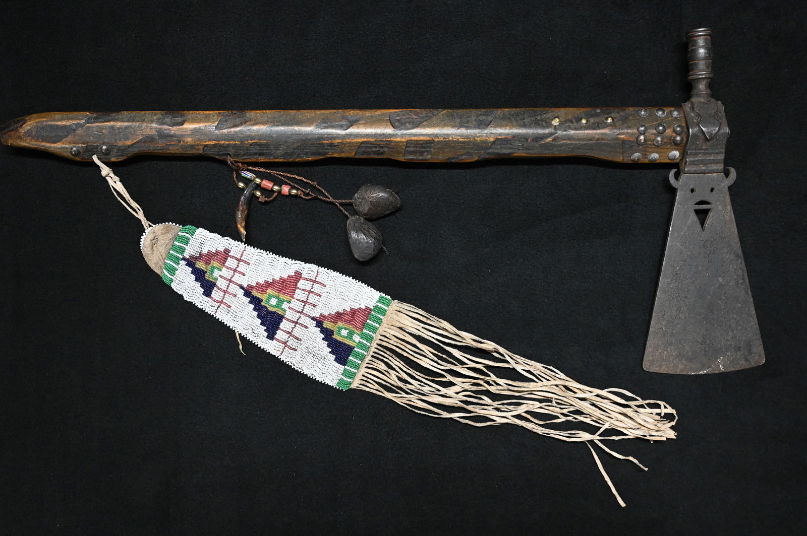 Buffalo Face Tomahawk Pipe with beaded drop and 24" tacked handle/stem. (1 of 13)