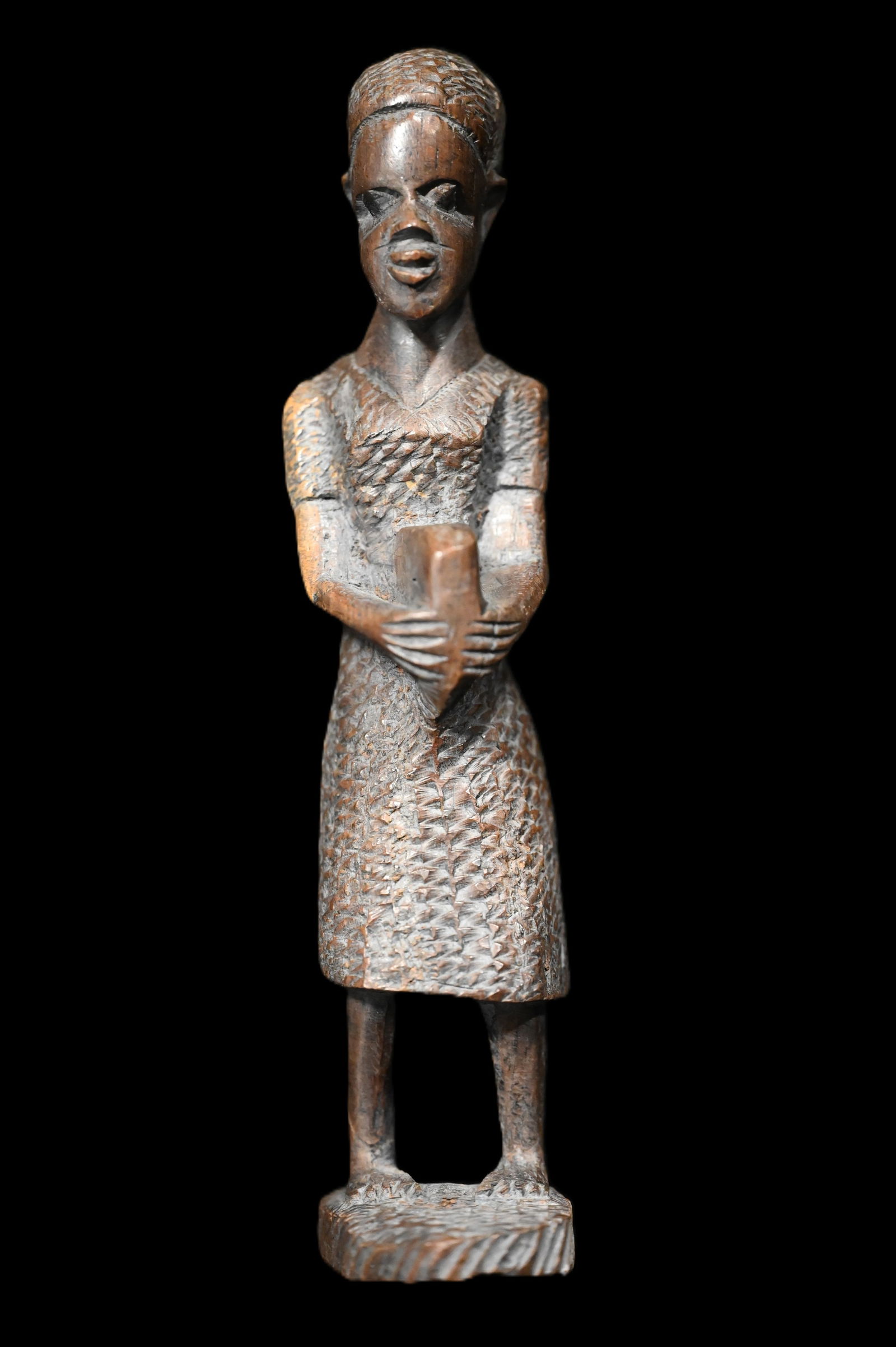 Makonde Tribe African Wood 9" Carving.: These carvings often depict figures with spiritual of cultural significance using materials like ebony or ironwood, characteristic of African tribal art. African sculptures are often used to represent