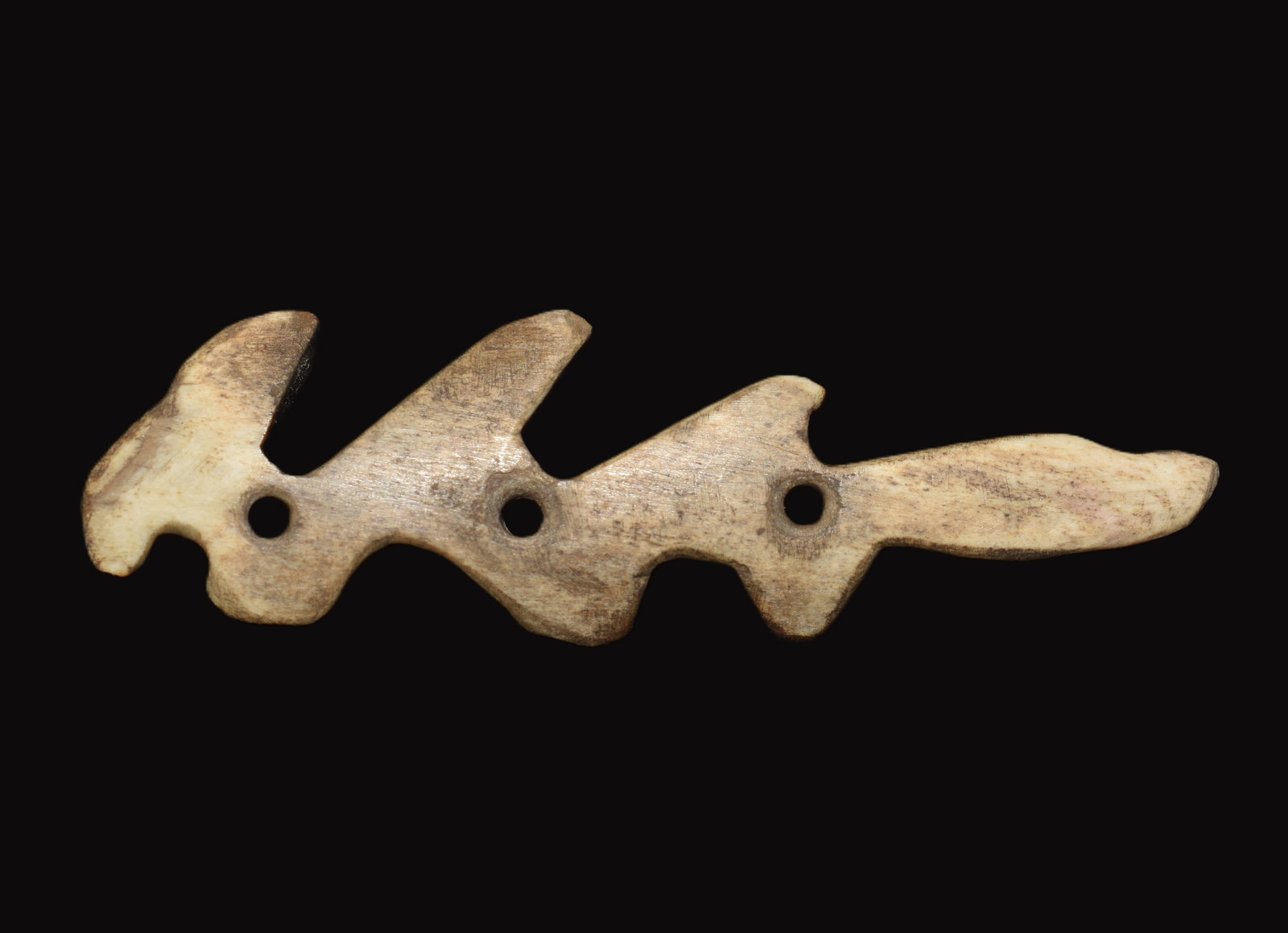 Historic Western Frontier Carved Bone Strap Spacer / Connector, 19th Century: This carved bone strap spacer or connector measures 2 1/4 inches and dates to the mid to late nineteenth century, originating from the American West, most likely the Great Basin or Plateau region.