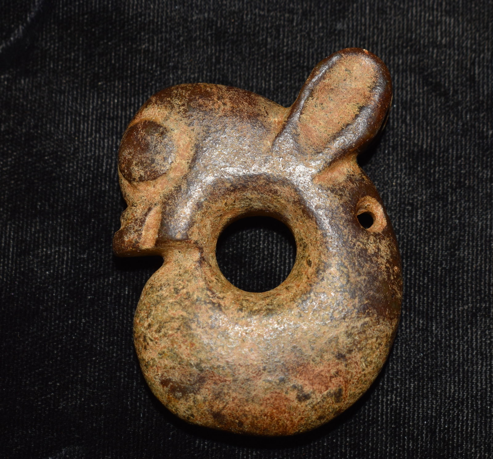 Hand Carved Archaic Style Chinese Stone Pig Dragon Pendant, Late Qing to Republic Period: Hand carved stone pendant in the form of a stylized pig dragon zhi long executed in an archaic Chinese folk art tradition. The curling body simplified head and incised line details echo ancient zoomor