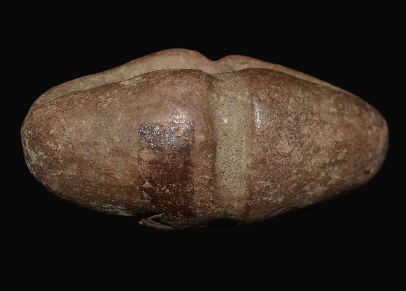 2 5/8" Cross-Grooved Stone Amulet - Maryland - Ex James Shield Collection: A well-crafted cross-grooved stone amulet fashioned from a dense reddish-brown fine-grained stone and reportedly recovered in Maryland. The artifact measures approximately 2¾ inches in length a