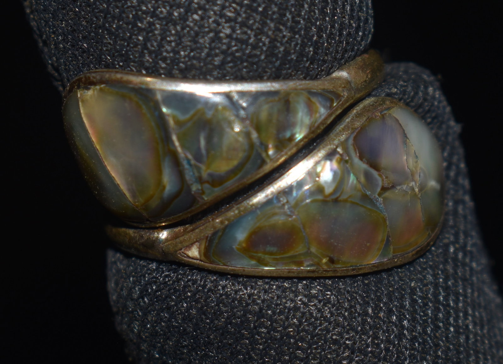 Vintage Sterling Silver Mother of Pearl Adjustable Wrap Ring: Sterling silver adjustable wrap ring featuring opposing mother of pearl inlay terminals in a bypass design. The polished nacre displays natural iridescence with flashes of white, cream, pink, green, a