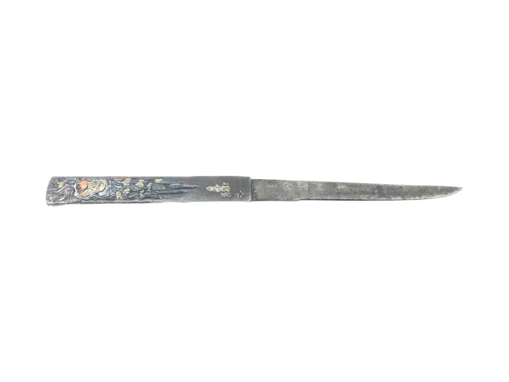Japanese Kogatana Kozuka Knife: signed blade with kanji characters, mixed metal relief decoration on one side of hilt, 4-3/4 in. blade, 8-1/4 in. overall, back side of hilt with tape or glue residue from mounting, small split to sid