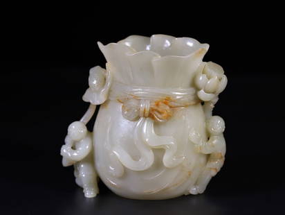 Hetian Jade Lotus and Auspicious Children Flower Vase: Hetian jade Lotus Birth Noble Son Flower Vase, made of Hetian jade, carved in the shapes of children, lotus flowers, sachets, etc. "Lotus giving birth to a son" symbolizes having many children and a h