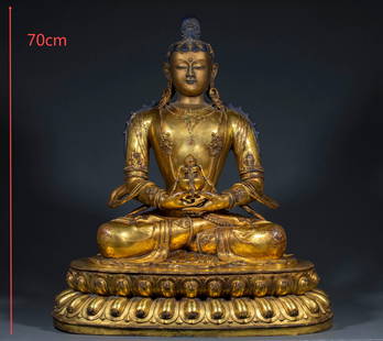 Gilt bronze seated Buddha holding a ritual object: A Gilt Buddha Statue Seated with Ritual Objects: Cast in metal (presumably copper), the surface is gilded to prevent rust and show solemnity. The Buddha statue is in a cross-legged sitting posture, ho