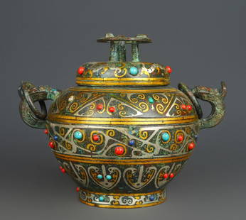 A round wine vessel with inlaid gold, silver and multiple gemstones: Inlaid Gold and Silver with Multiple Gemstones Circular Vessel: Made of bronze with gold and silver inlay (gold and silver wires embedded in the bronze vessel's patterns) and multiple gemstones (red,
