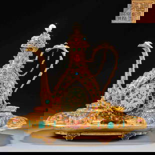 Gilt Copper Inlaid with Multiple Precious Stones Tea Set: A set of copper-gilt tea sets inlaid with multiple precious stones: The base is pure gold, and the teapot, cups and tray are shaped through casting and engraving techniques. They are inlaid with green