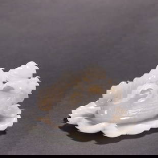 Hetian white jade ornament of a goose holding a lotus, Qing Dynasty: This Qing Dynasty white jade goose holding lotus flower ornament is made of white jade from Hotan. It is carved in the round to depict a goose holding a lotus flower. The goose's feathers are depicted
