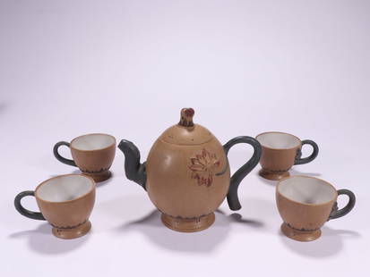 Set of purple clay teapot with lotus patterns, made of Duan clay and marked with Jiang Rong's: A set of purple clay tea sets with lotus patterns by Jiang Rong: Made from selected purple clay, this set is crafted through techniques such as sculpture and painting. The body of the teapot is decora