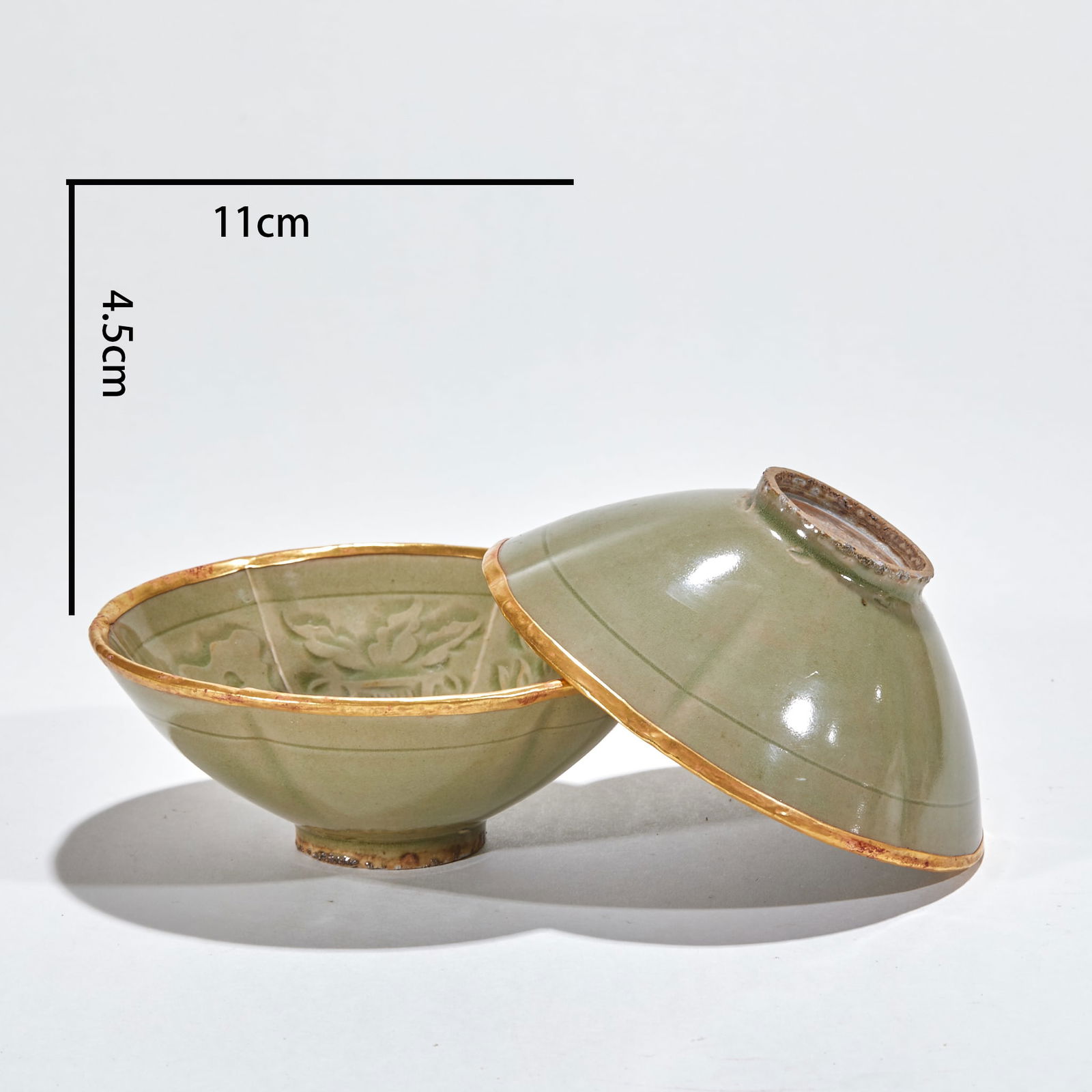 A Pair of Carved Tiger-Patterned Auspicious Cups, Yaozhou Kiln, Northern Song Dynasty: Pair of Northern Song Dynasty Yaozhou Kiln Carved Tiger Pattern Auspicious Cups, height 4.5cm, diameter 11cm, celadon porcelain with gold-plated rims. Using carved and incised flower techniques, the