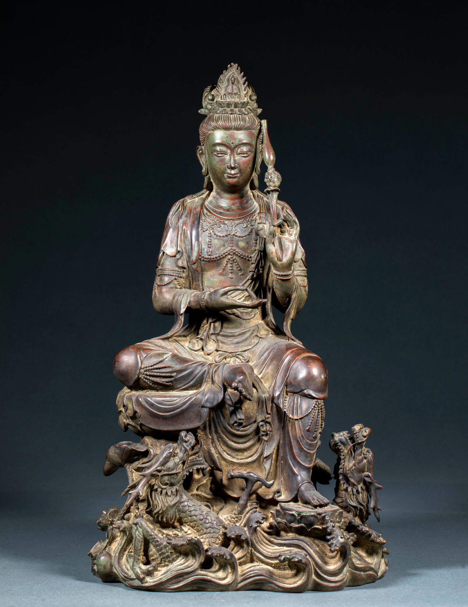 Bronze Statue of Guanyin Riding a Dragon, Pre-Ming Dynasty: Pre-Ming Dynasty Bronze Guanyin Riding a Dragon Statue, height 39cm, length 22cm, width 16.5cm, weight 7000g, bronze with partial gilding and painting. Guanyin is seated in the lotus position on the